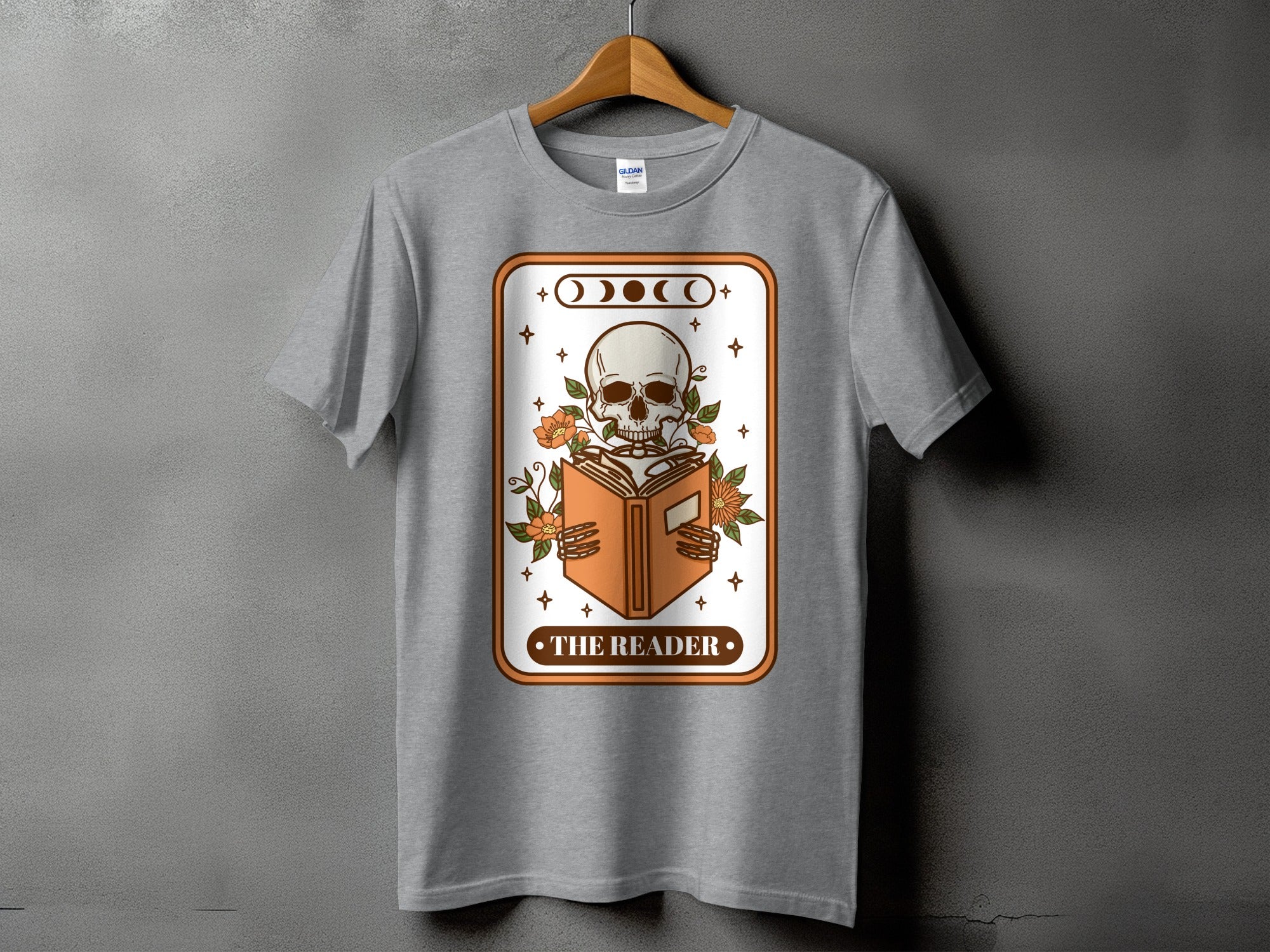 Gray t-shirt with a skeleton reading a book design titled "The Reader".