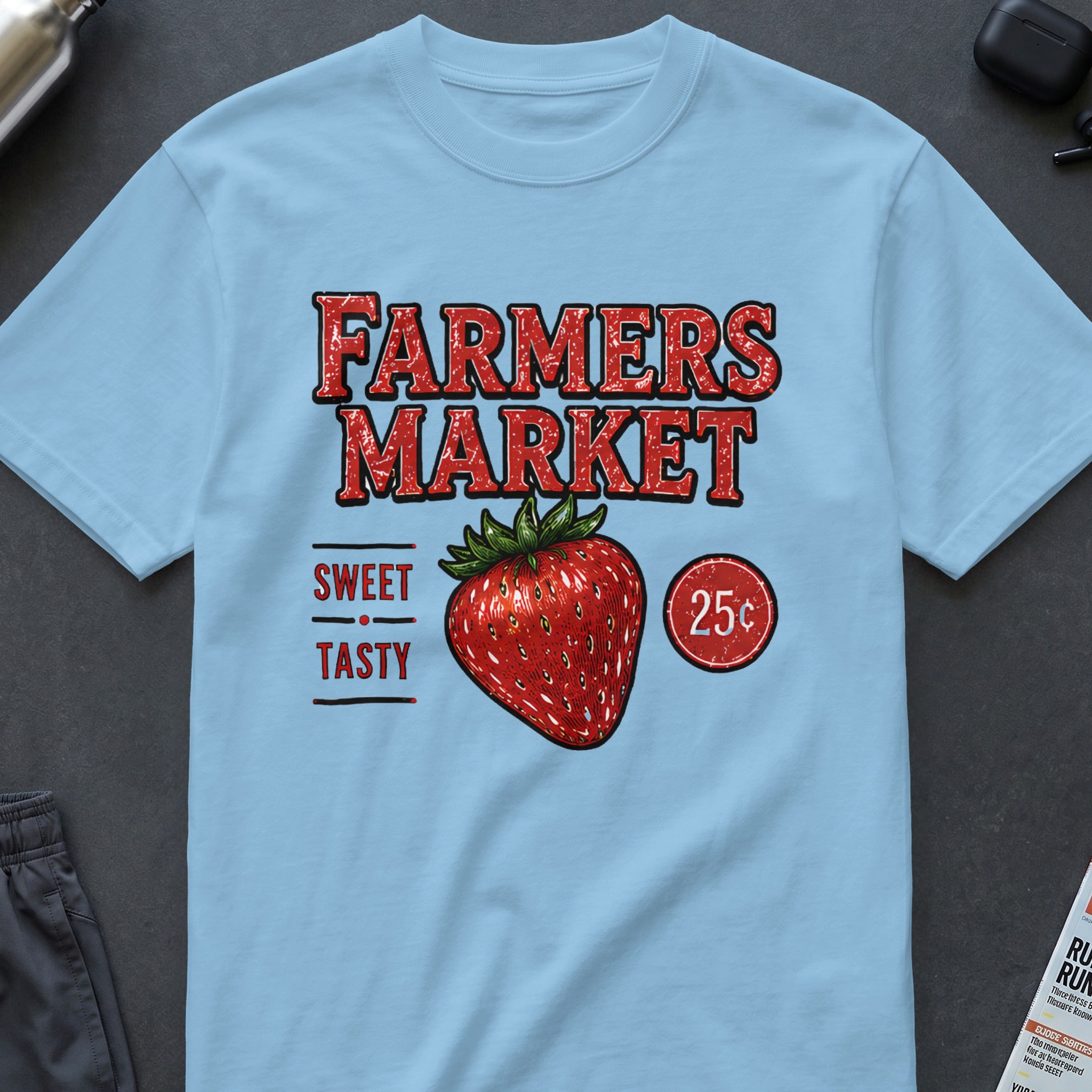 Light blue t-shirt with "FARMERS MARKET" text, strawberry, and "SWEET TASTY 25¢".