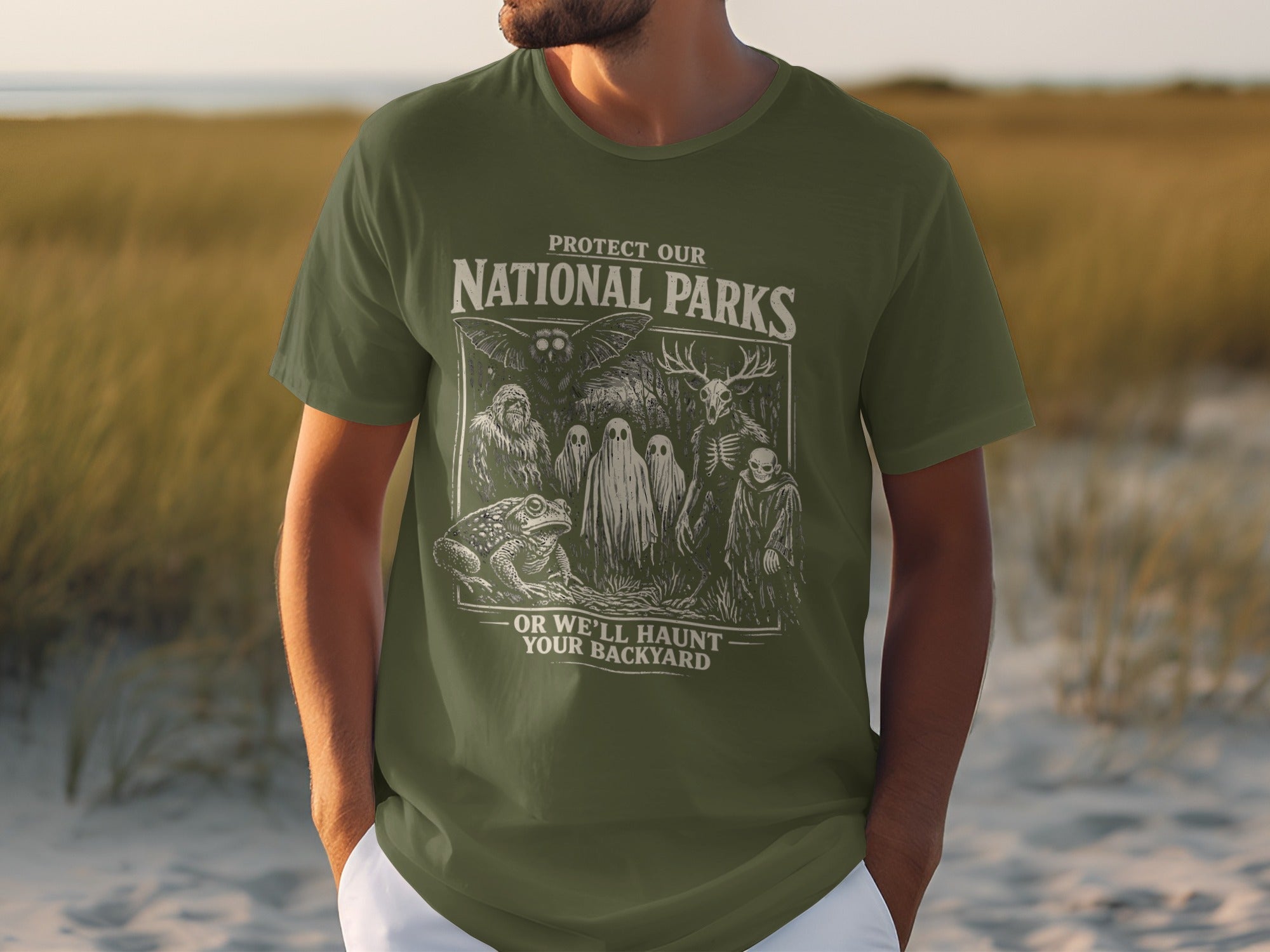 Green t-shirt with "Protect Our National Parks Or We'll Haunt Your Backyard" graphic.
