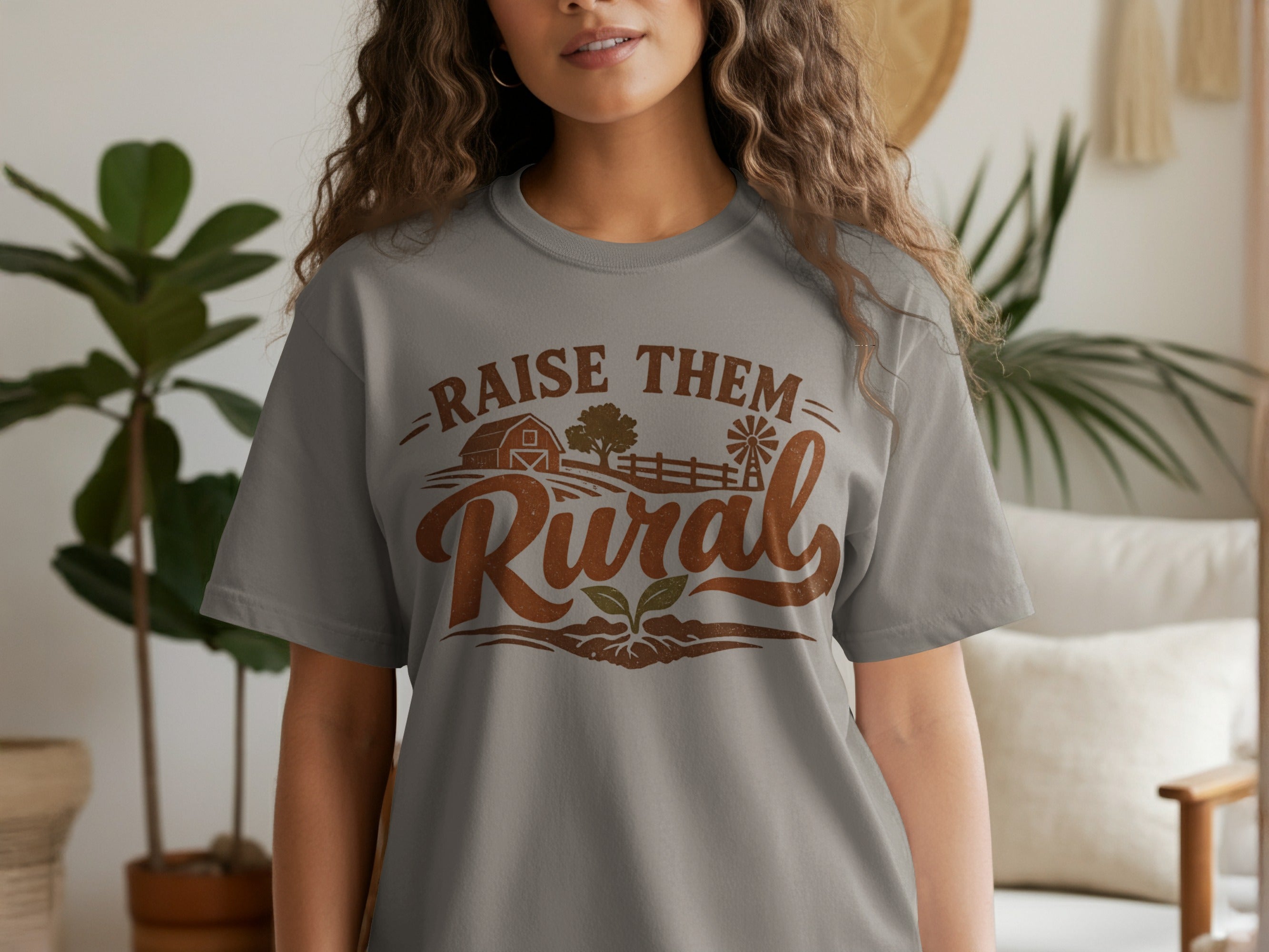 Gray t-shirt with "Raise Them Rural" text and farm graphic.