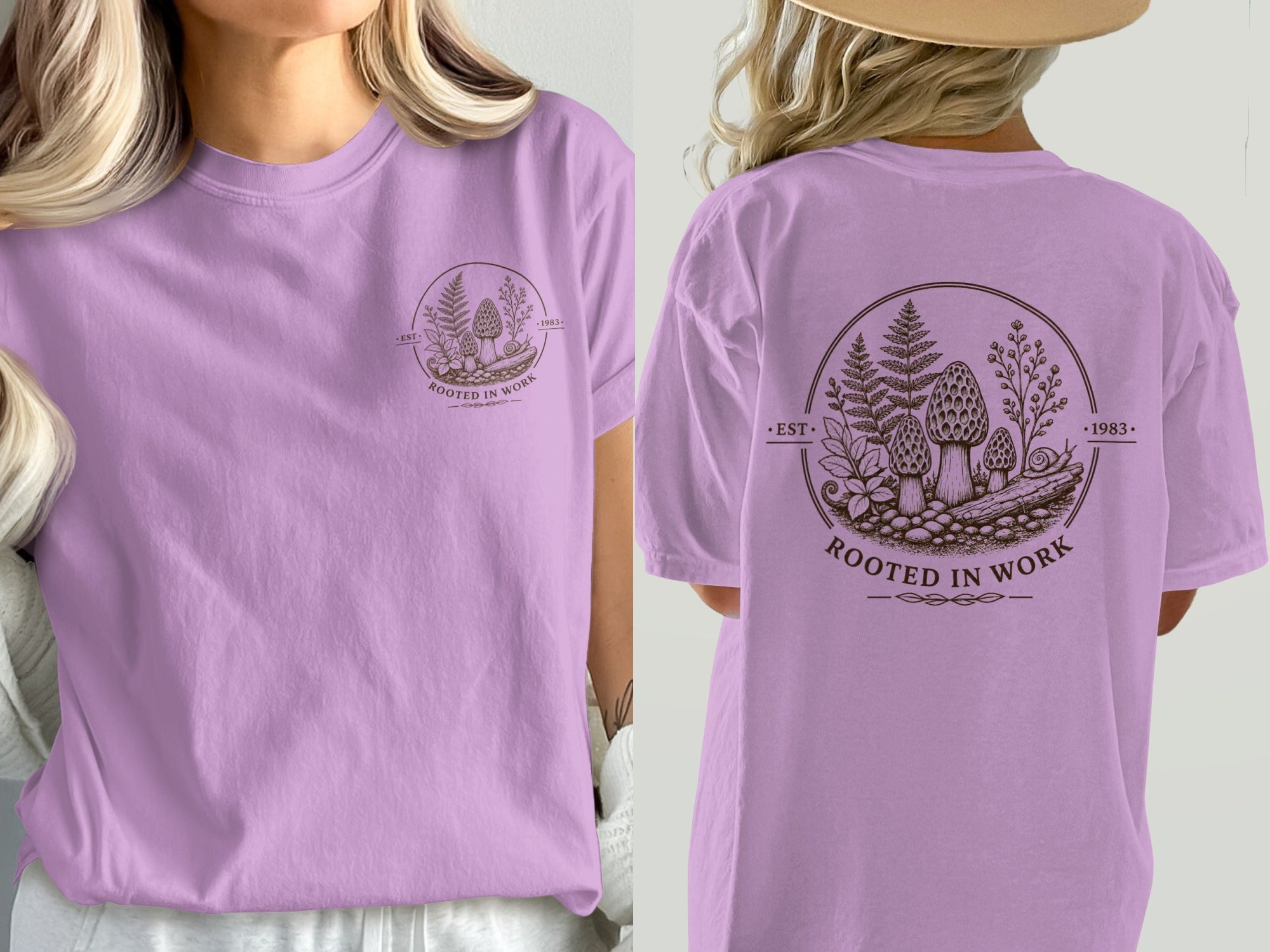 Lavender t-shirt with circular graphic of mushrooms, ferns, and text "Rooted in Work 1983".