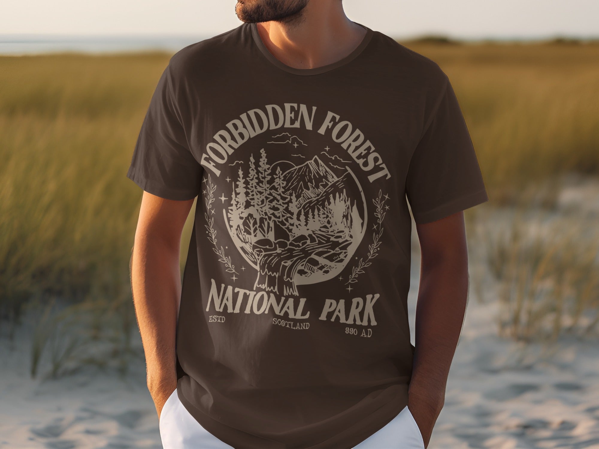Dark brown t-shirt with "Forbidden Forest National Park Scotland 990 AD" graphic.