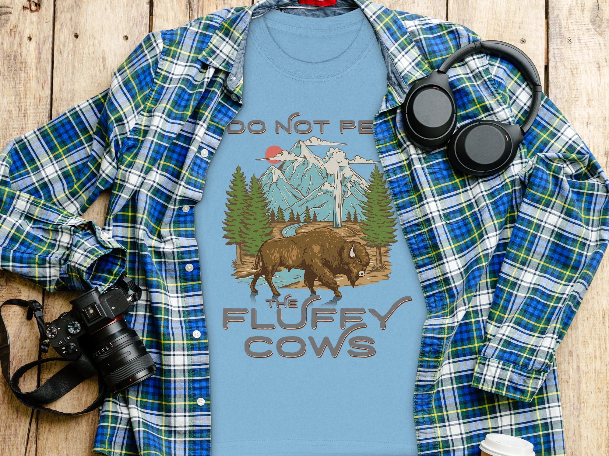 Light blue t-shirt with bison, mountains, and "Do Not Pet the Fluffy Cows" text.