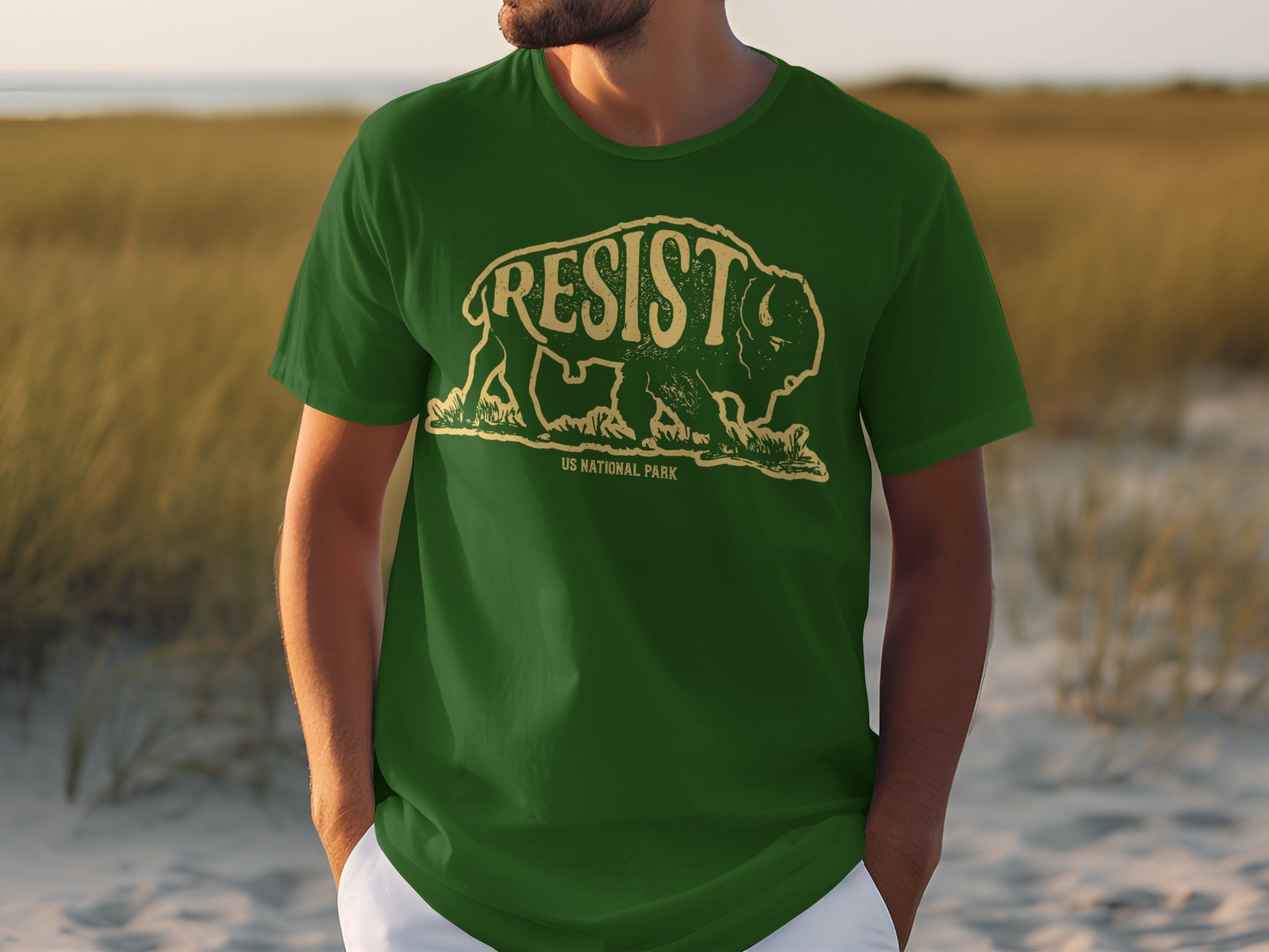 Green t-shirt with a bison graphic and text "RESIST US NATIONAL PARK".