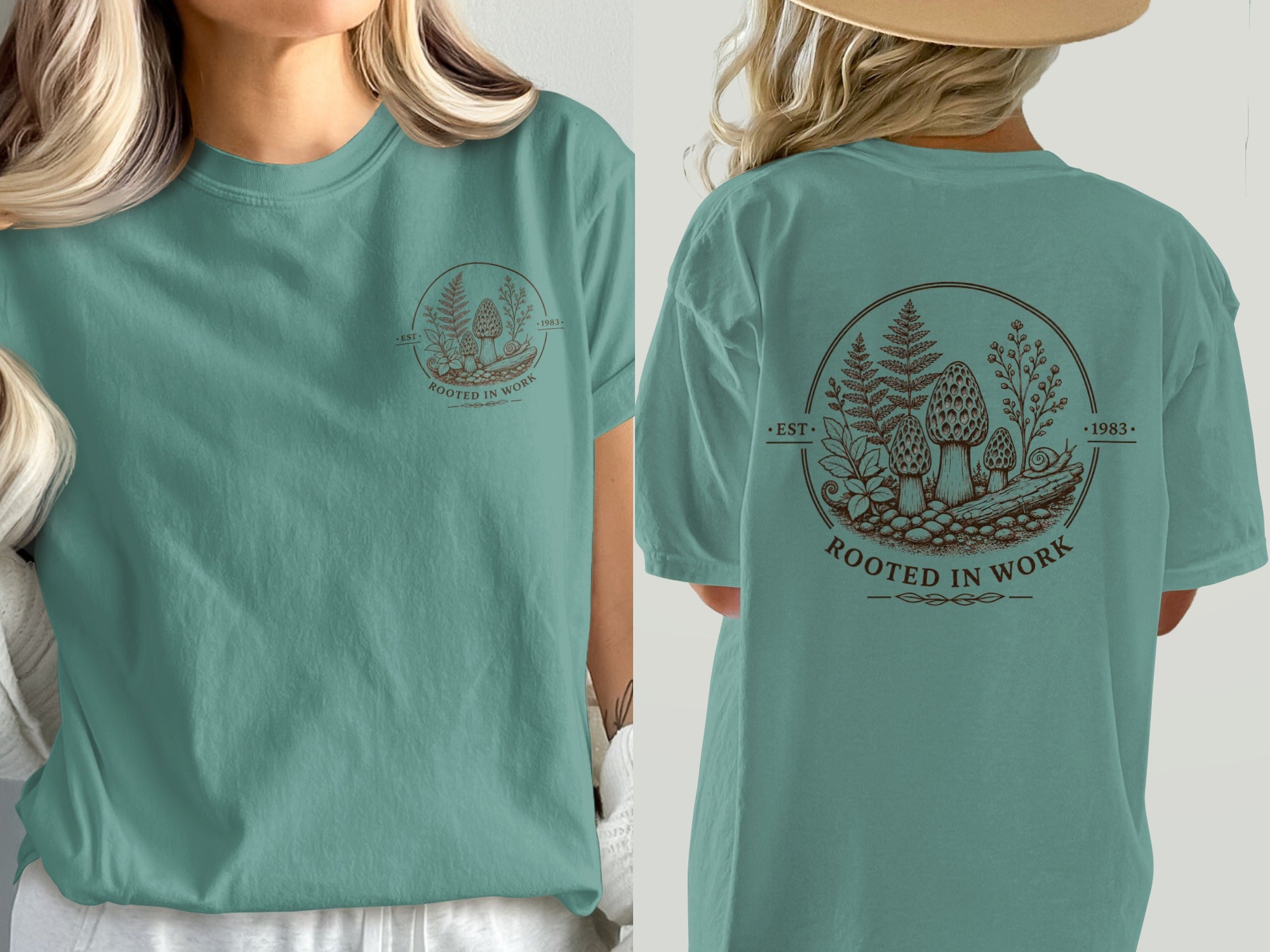 Teal t-shirt with circular brown graphic of mushrooms, ferns, and text "Rooted in Work".