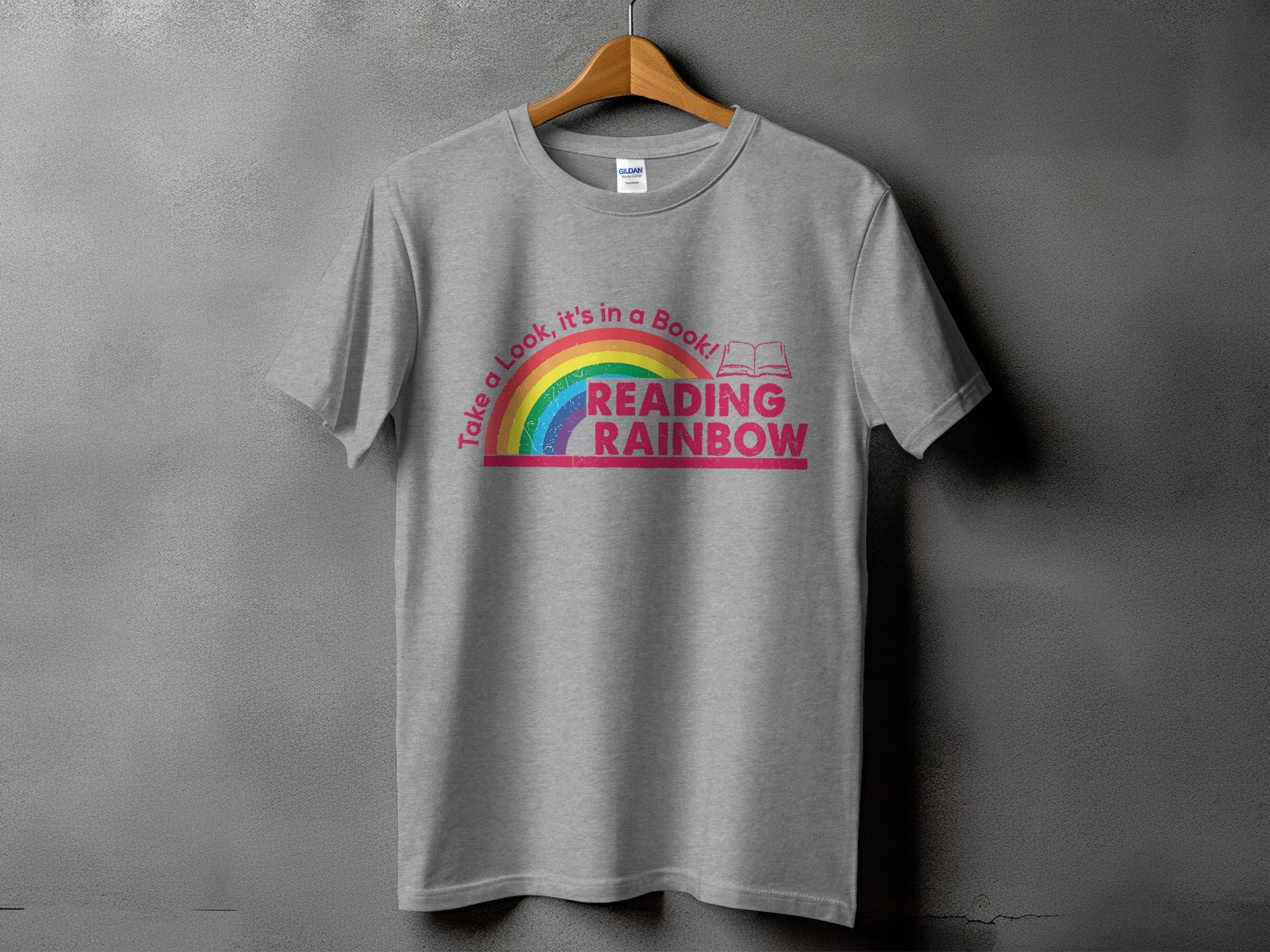 Grey t-shirt with "Take a Look, it's in a Book! READING RAINBOW" text and rainbow graphic.
