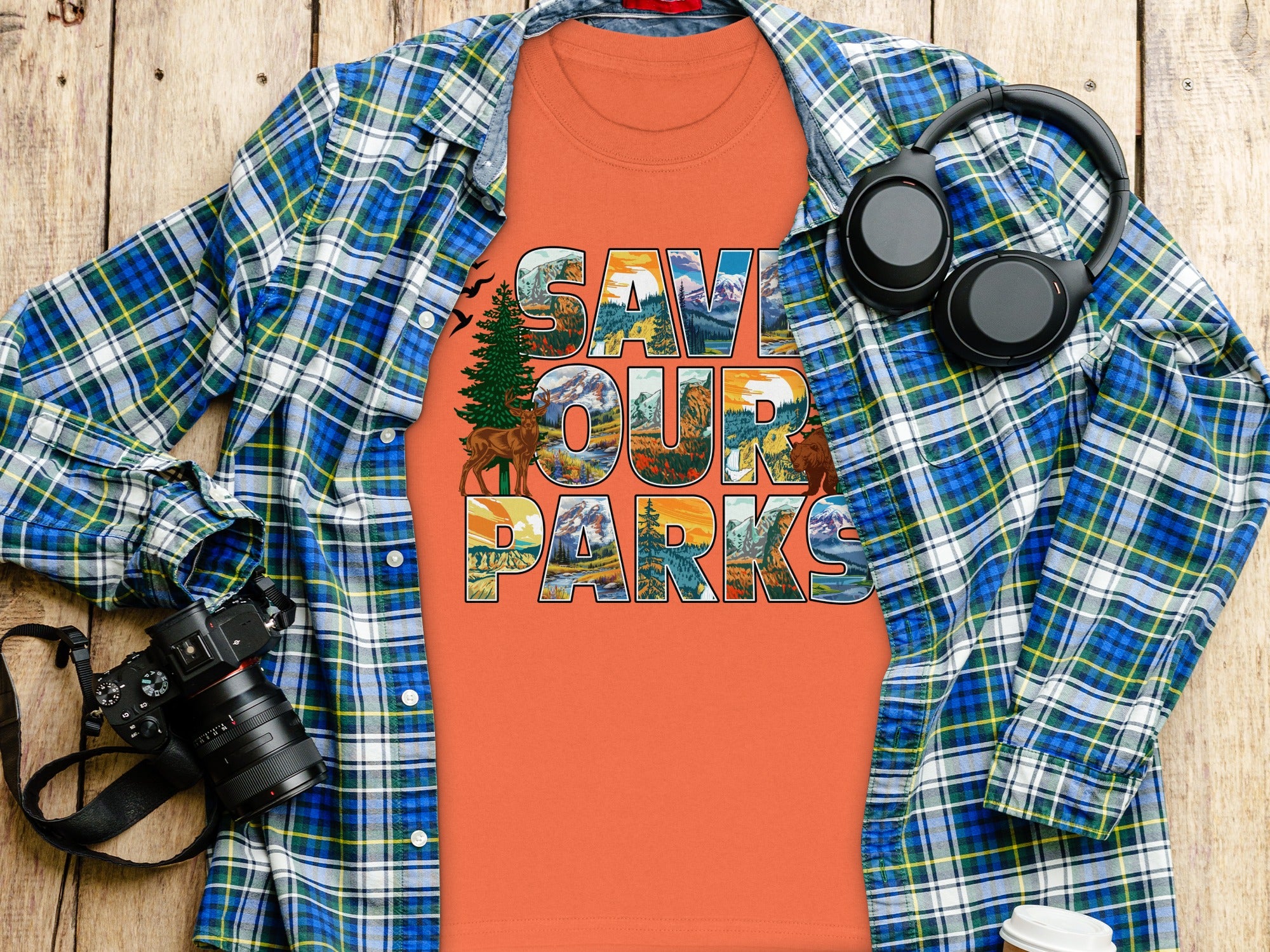 Orange t-shirt with "SAVE OUR PARKS" text featuring mountain and forest scenery.