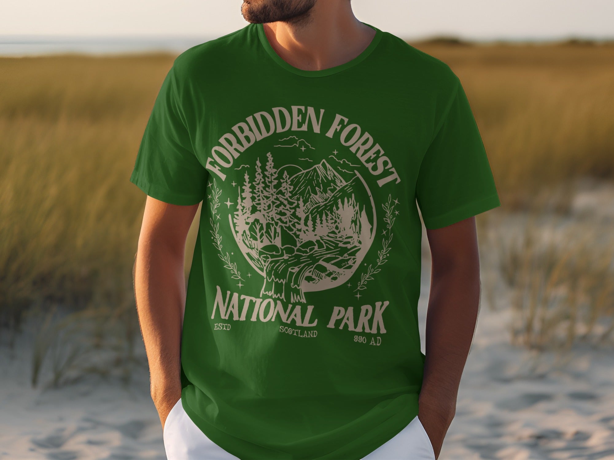 Green t-shirt with "Forbidden Forest National Park" circular graphic and mountain design.