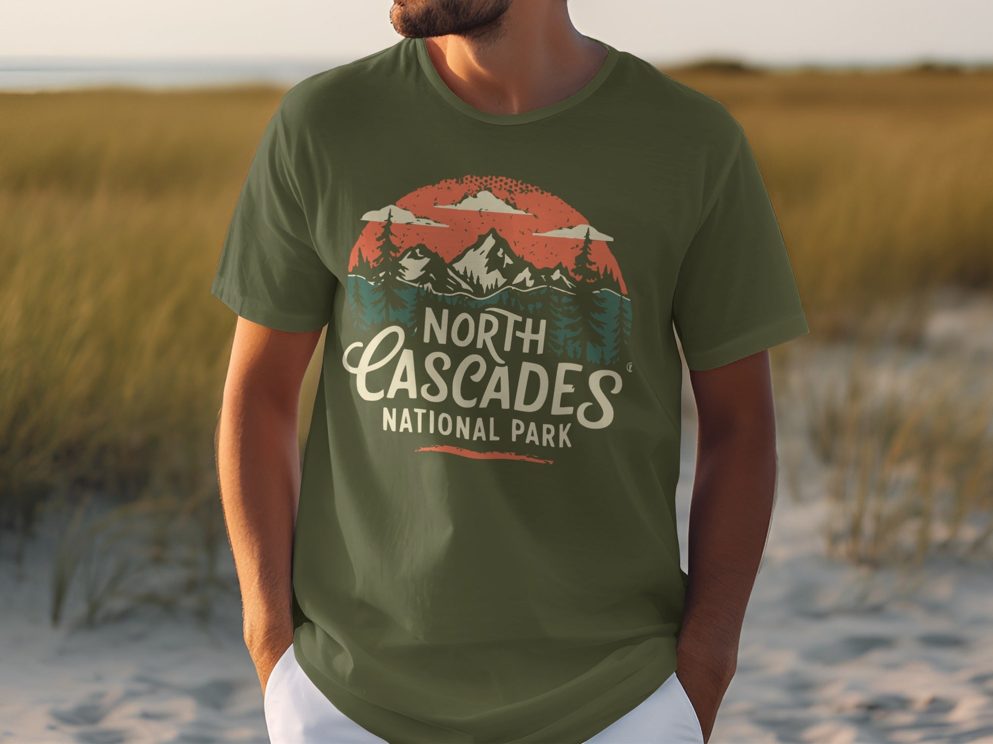 Green t-shirt with "North Cascades National Park" text and mountain scenery graphic.