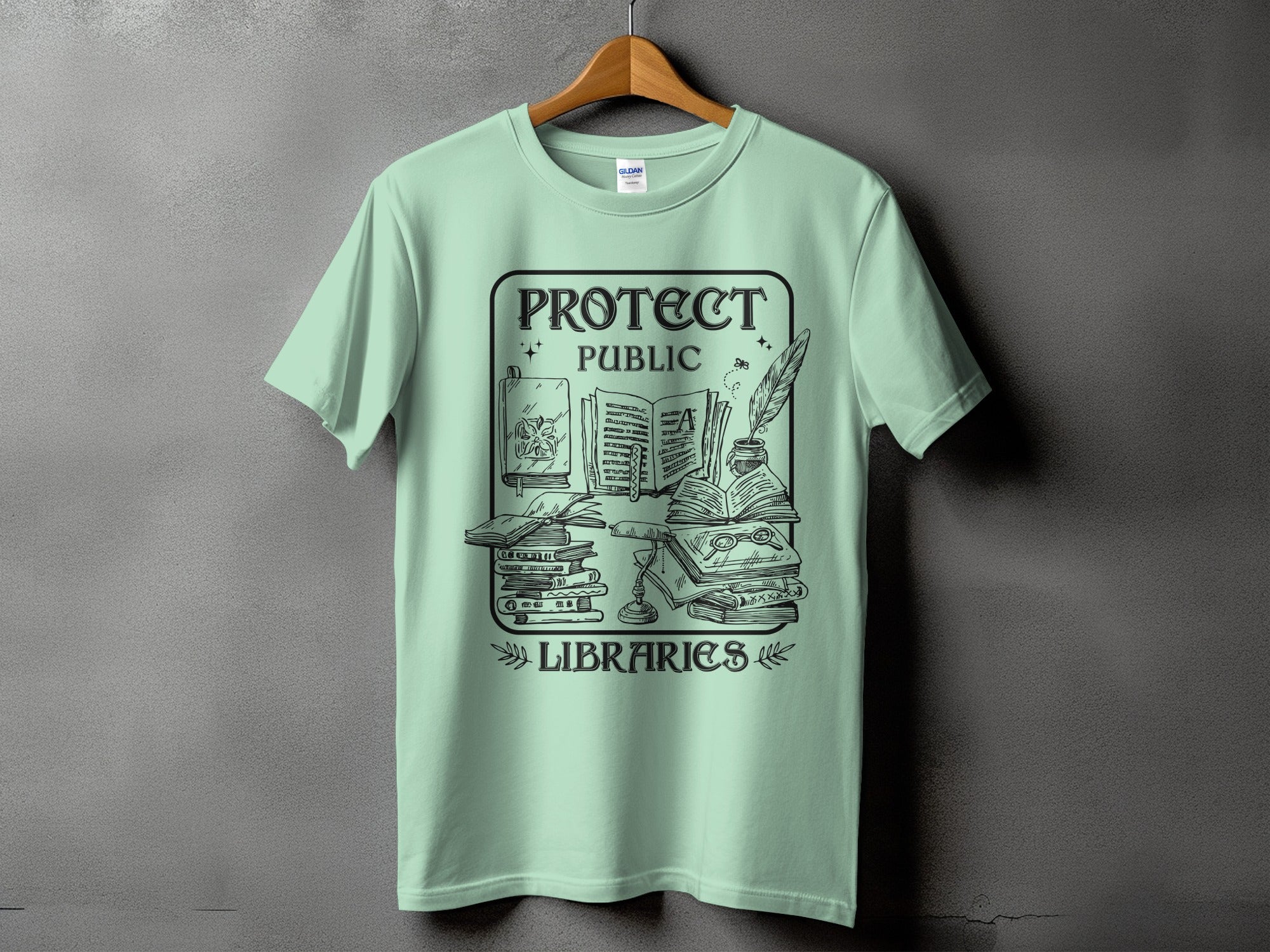 T-shirt with "Protect Public Libraries" graphic of books, inkwell, and feather.