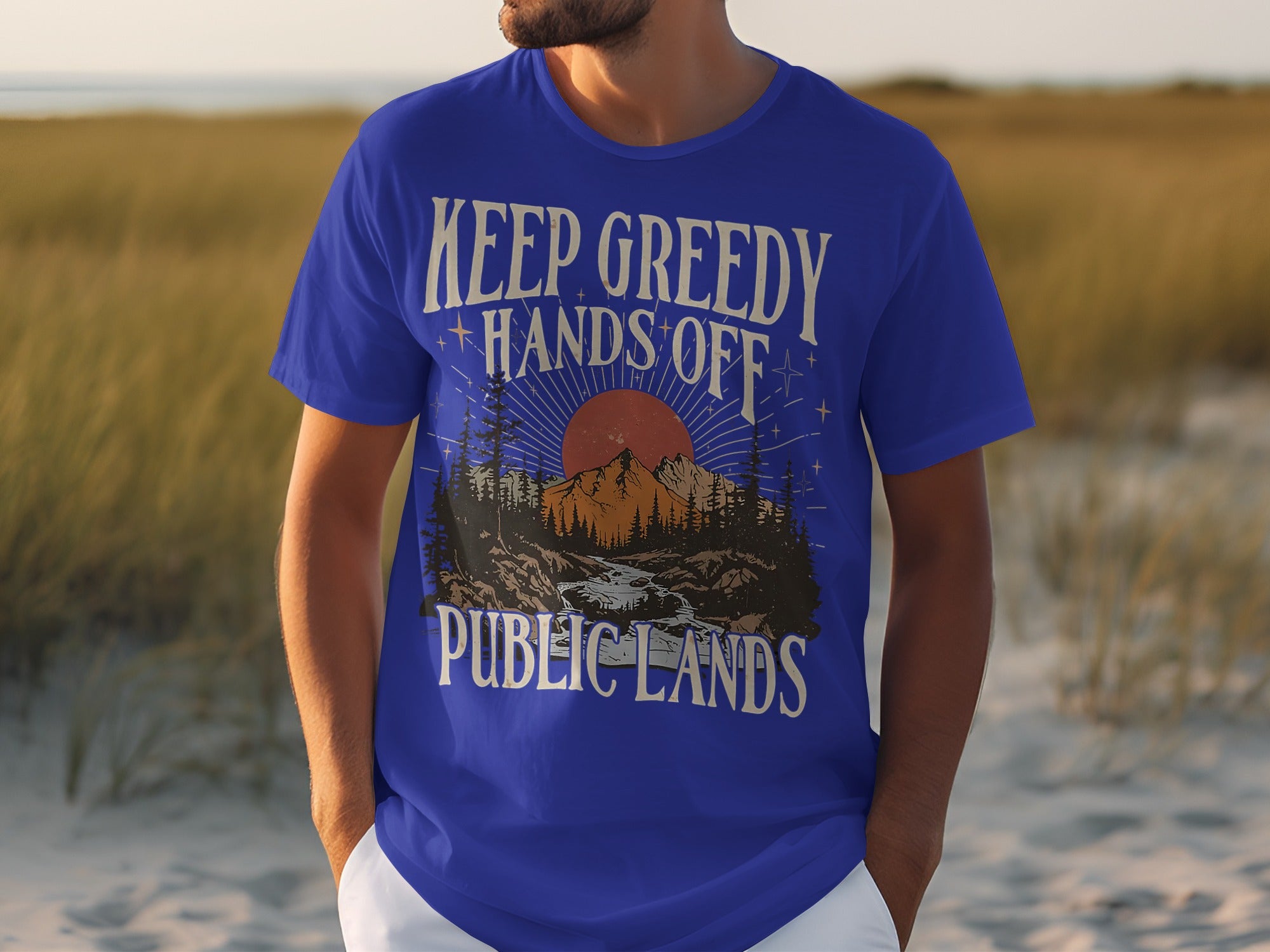 Blue t-shirt with "Keep Greedy Hands Off Public Lands" graphic.