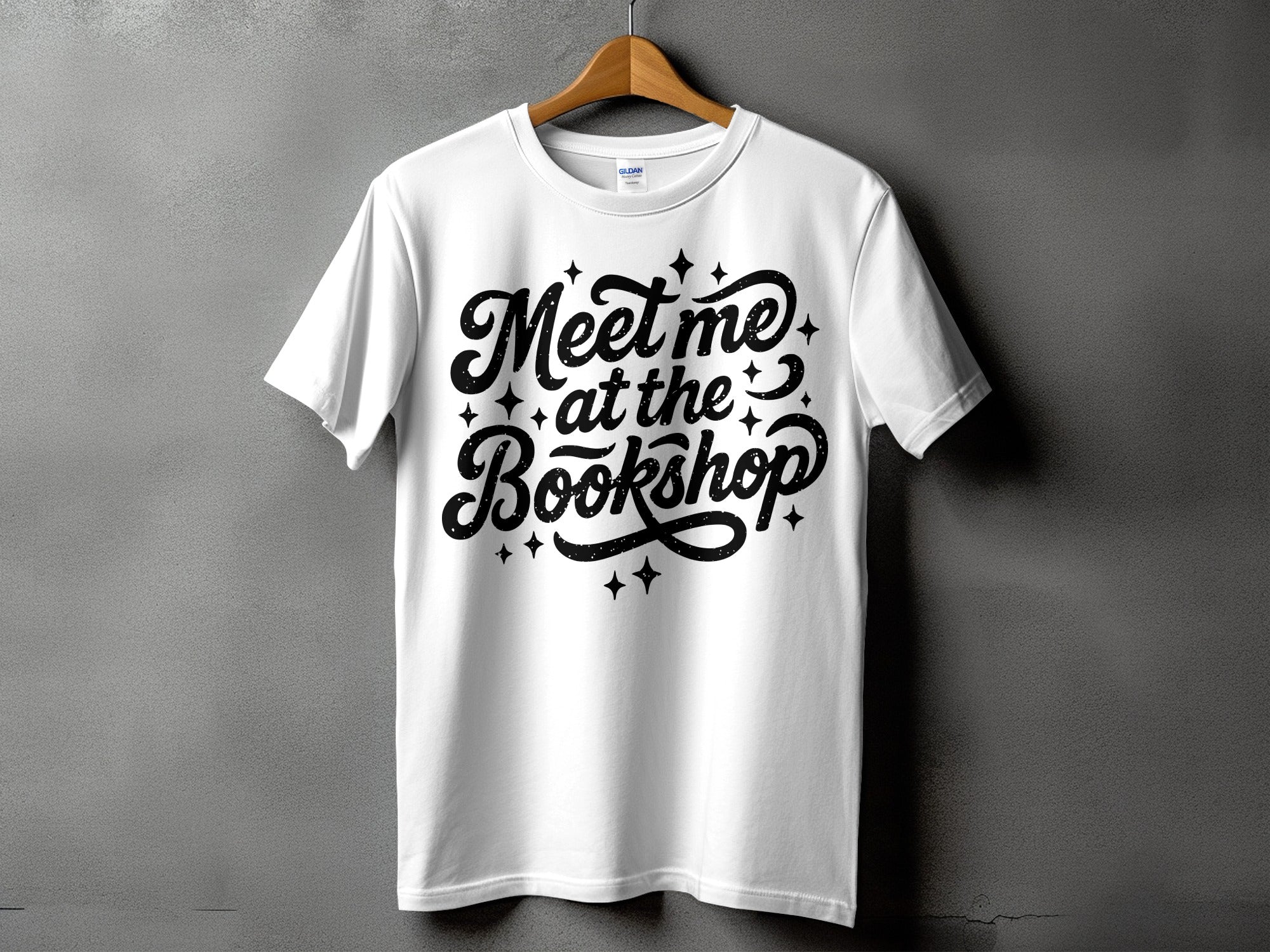 White t-shirt with black text and stars that reads "Meet me at the Bookshop"