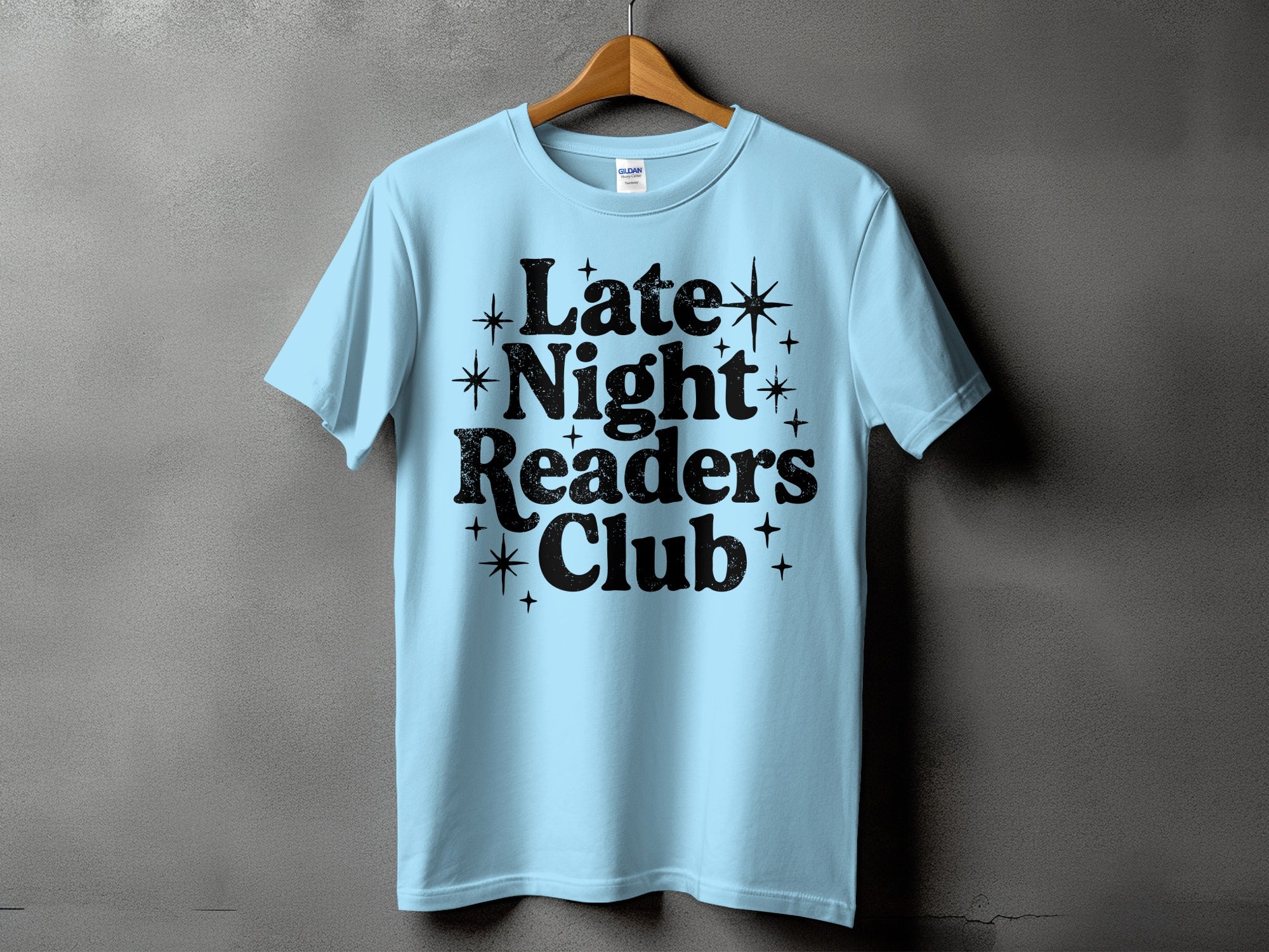 Light blue t-shirt with black text reading "Late Night Readers Club".
