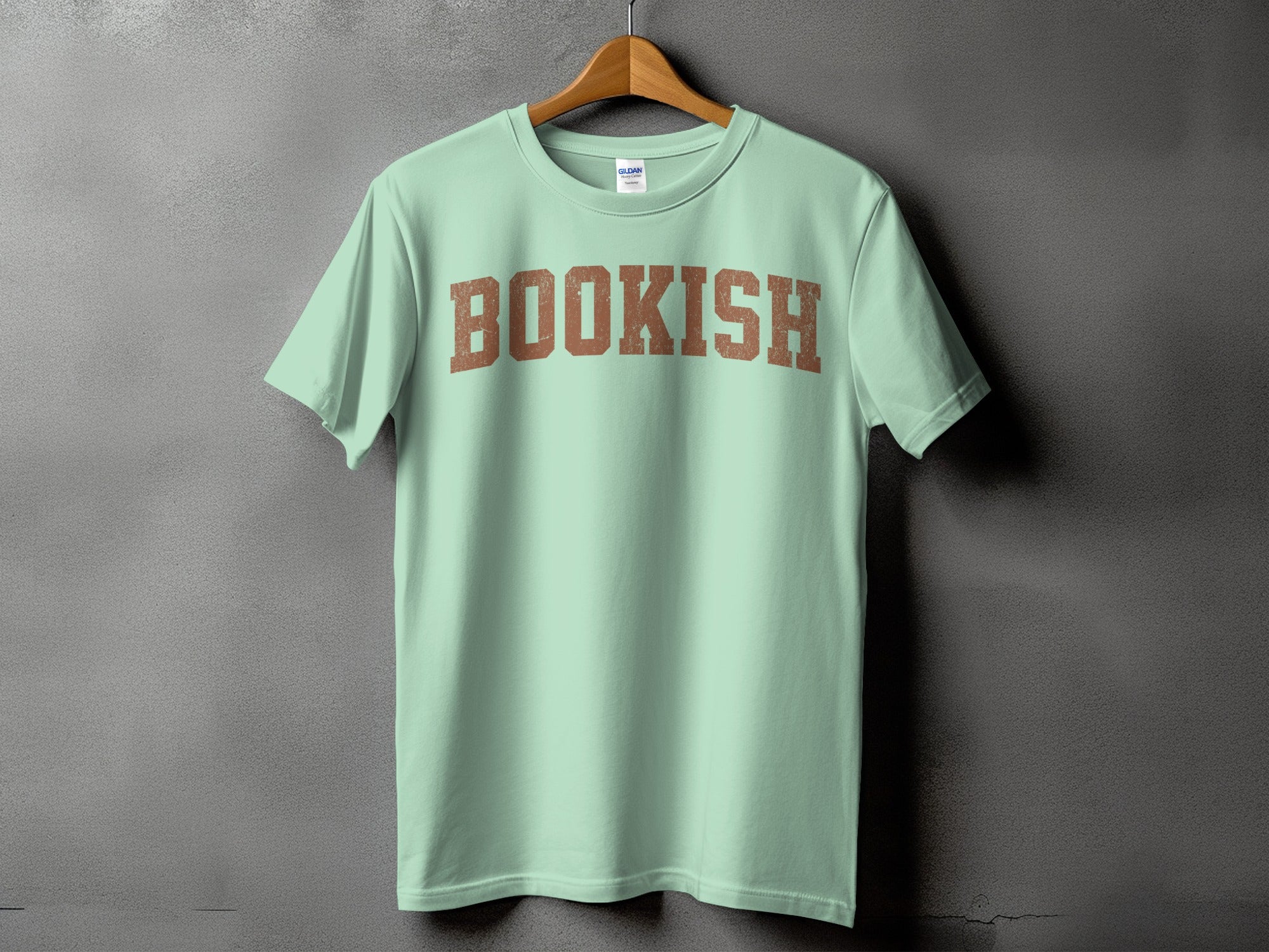 Light mint green t-shirt with distressed brown "BOOKISH" text across the chest.