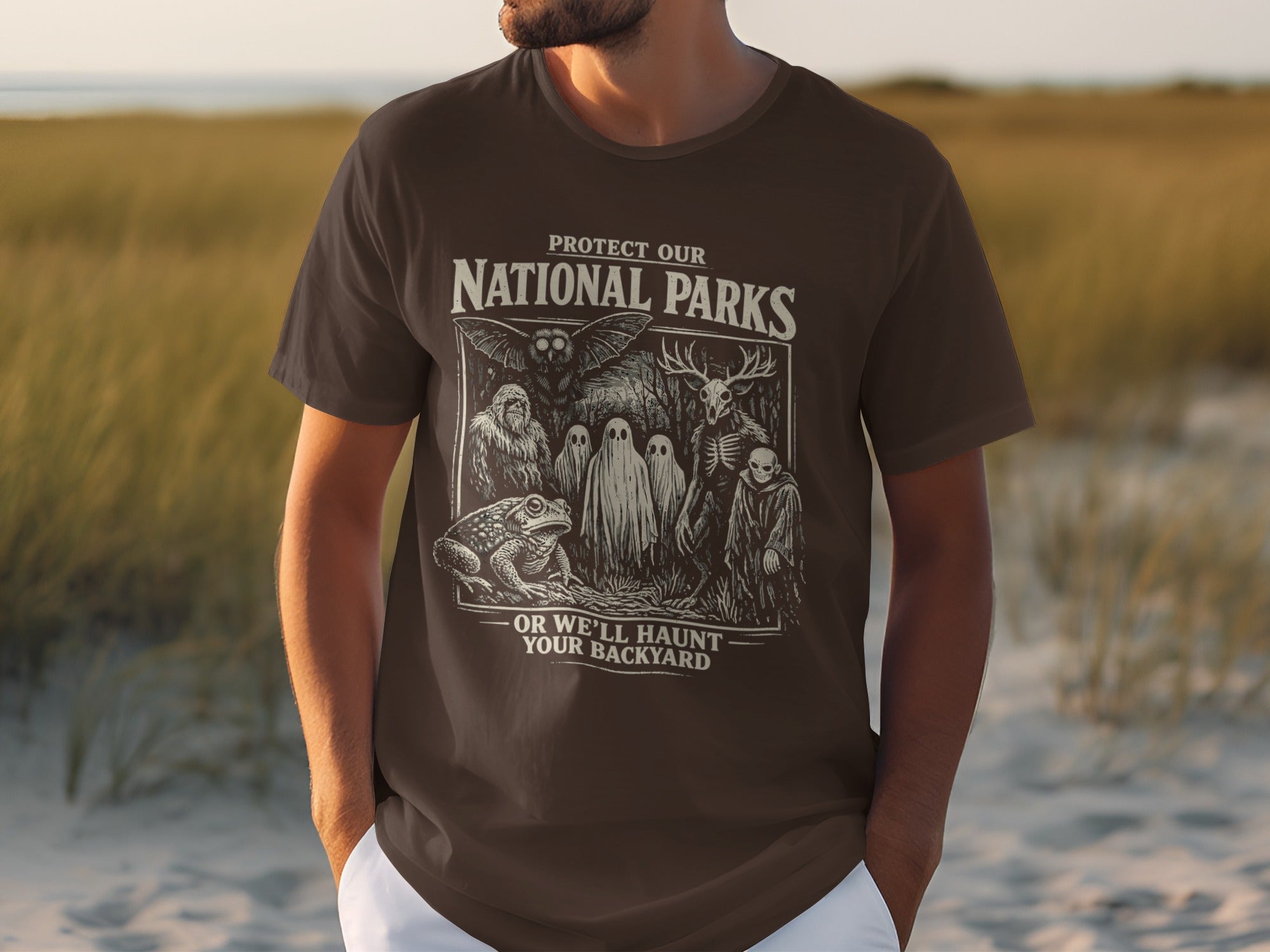 Brown t-shirt with "Protect Our National Parks" and spooky creatures.