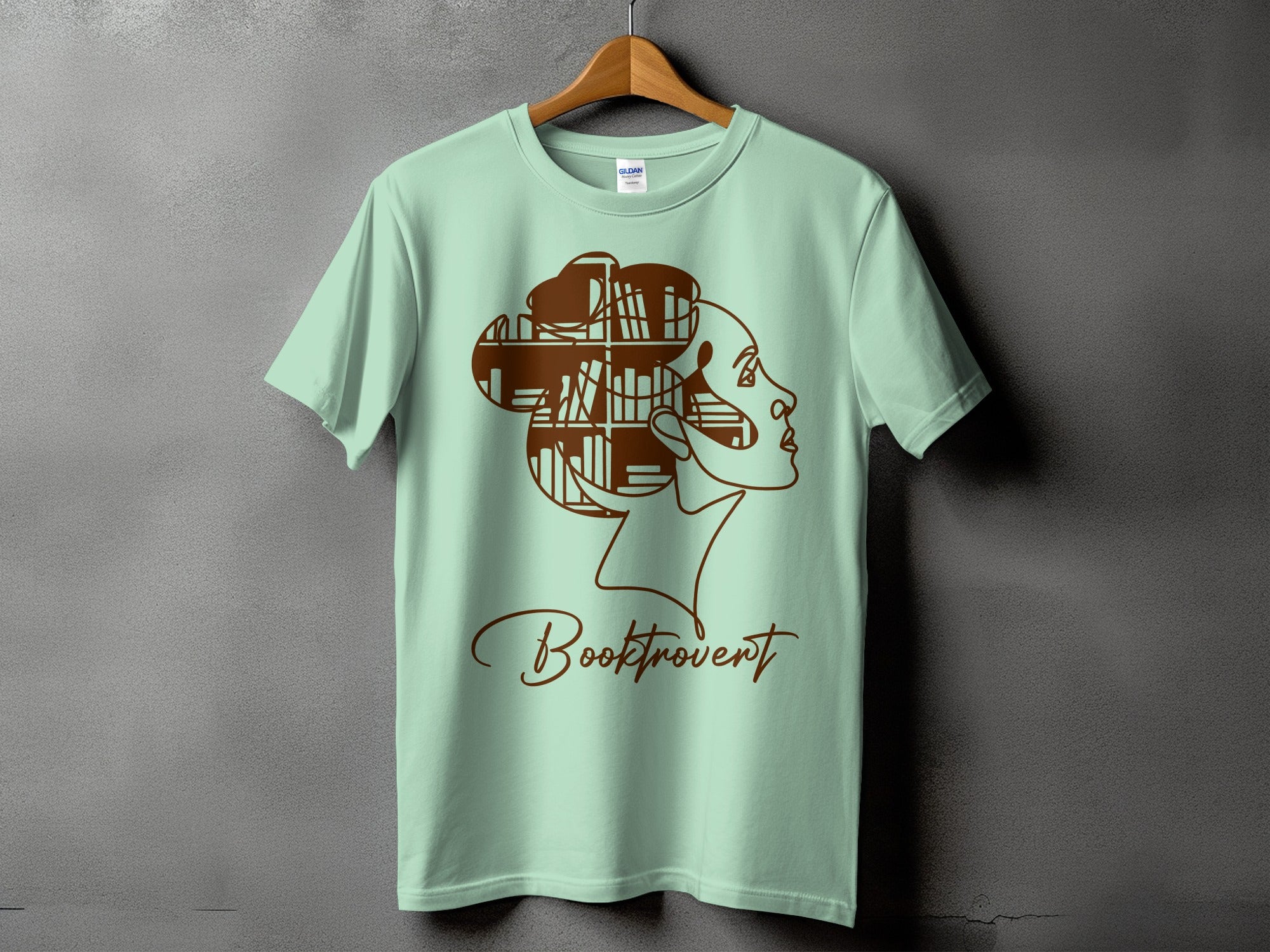 Light mint green t-shirt with brown bookshelf hair and "Booktrovert" text.