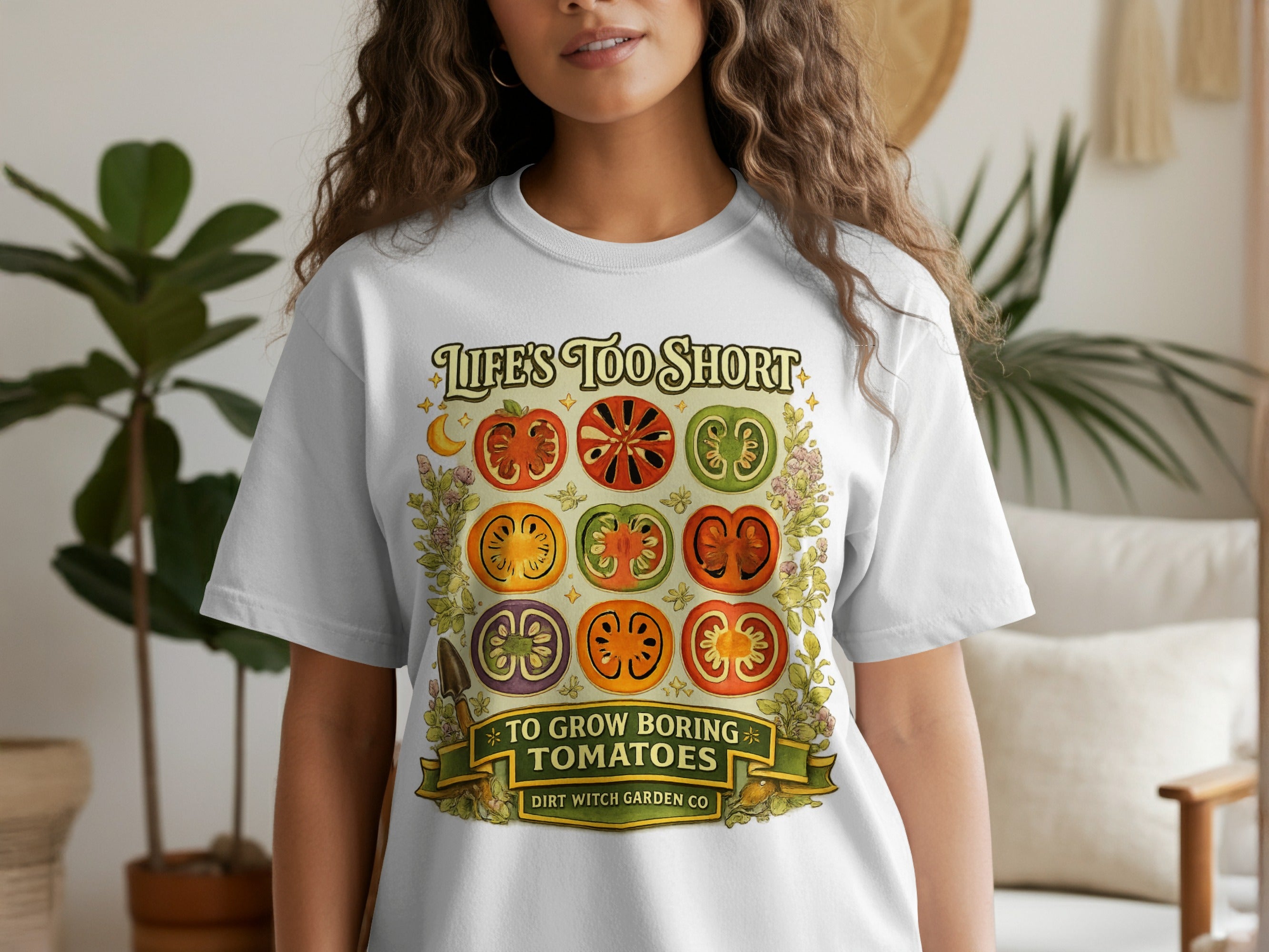 White t-shirt with illustration of sliced tomatoes and "Life's Too Short To Grow Boring Tomatoes" text.