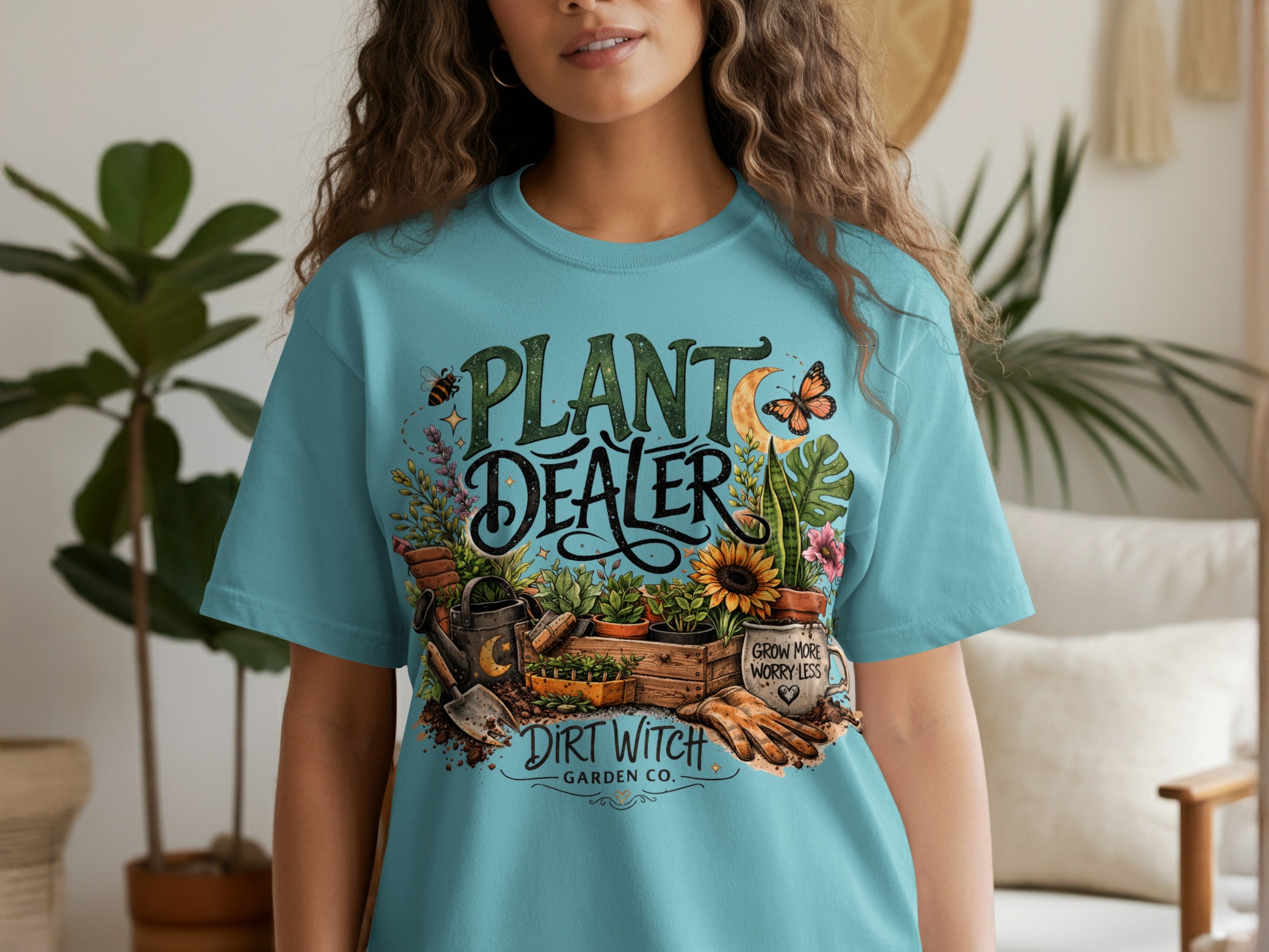 Teal t-shirt with "Plant Dealer" graphic, gardening tools, plants, and "Dirt Witch Garden Co.".