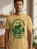 T-shirt with green graphic of bear on tree stump, trees, and text "Protect Our National Parks".