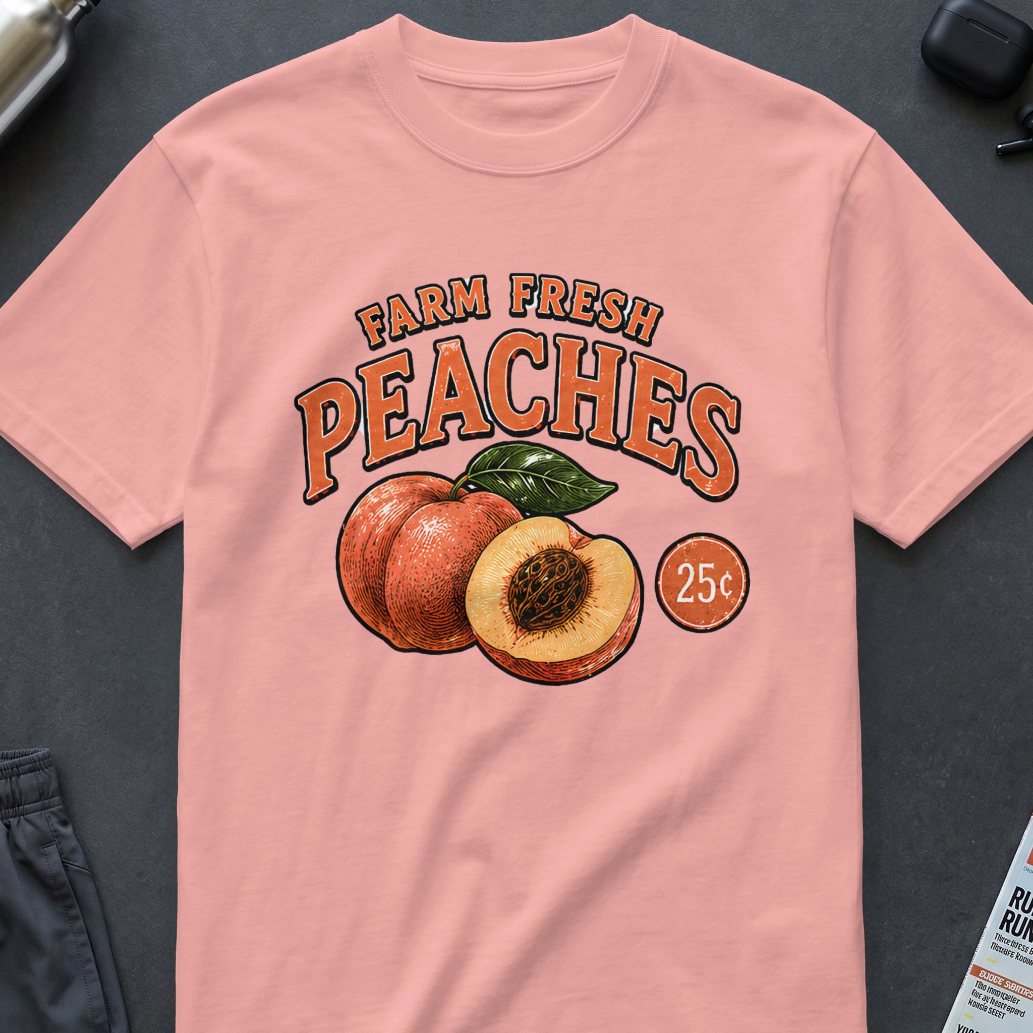 Peach graphic with "Farm Fresh Peaches 25c" text on a pink t-shirt.