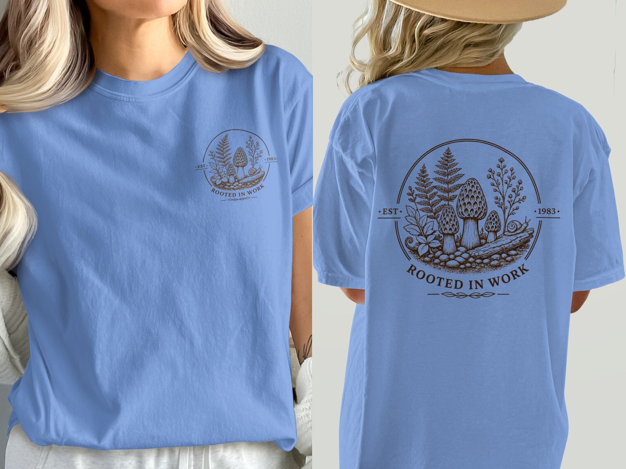 Blue t-shirt with embroidered mushroom and fern design with text "ROOTED IN WORK" and "1983".