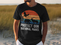 Black t-shirt with "Protect Our National Parks" text and wildlife graphic.