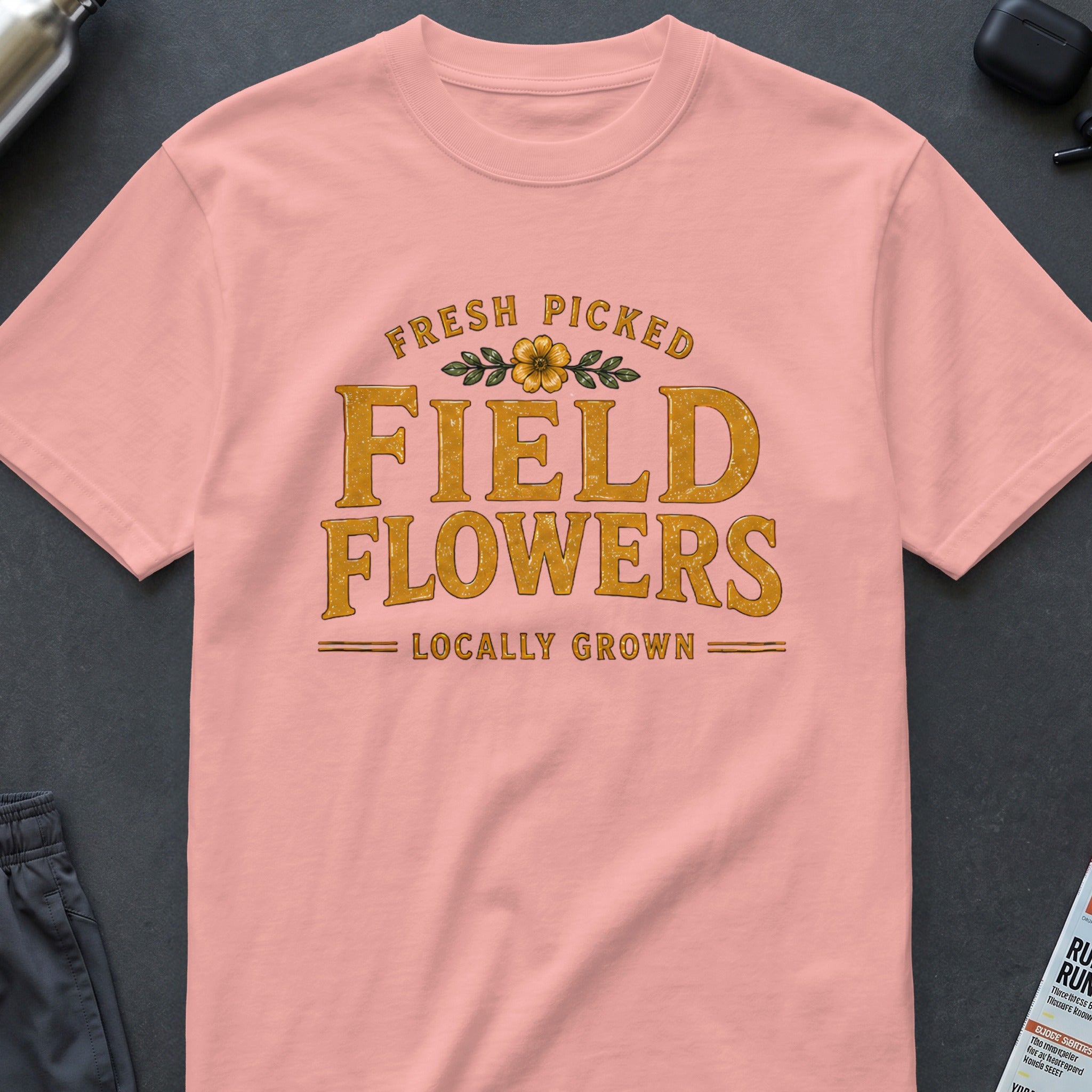 Pink t-shirt with "FRESH PICKED FIELD FLOWERS LOCALLY GROWN" text graphic.