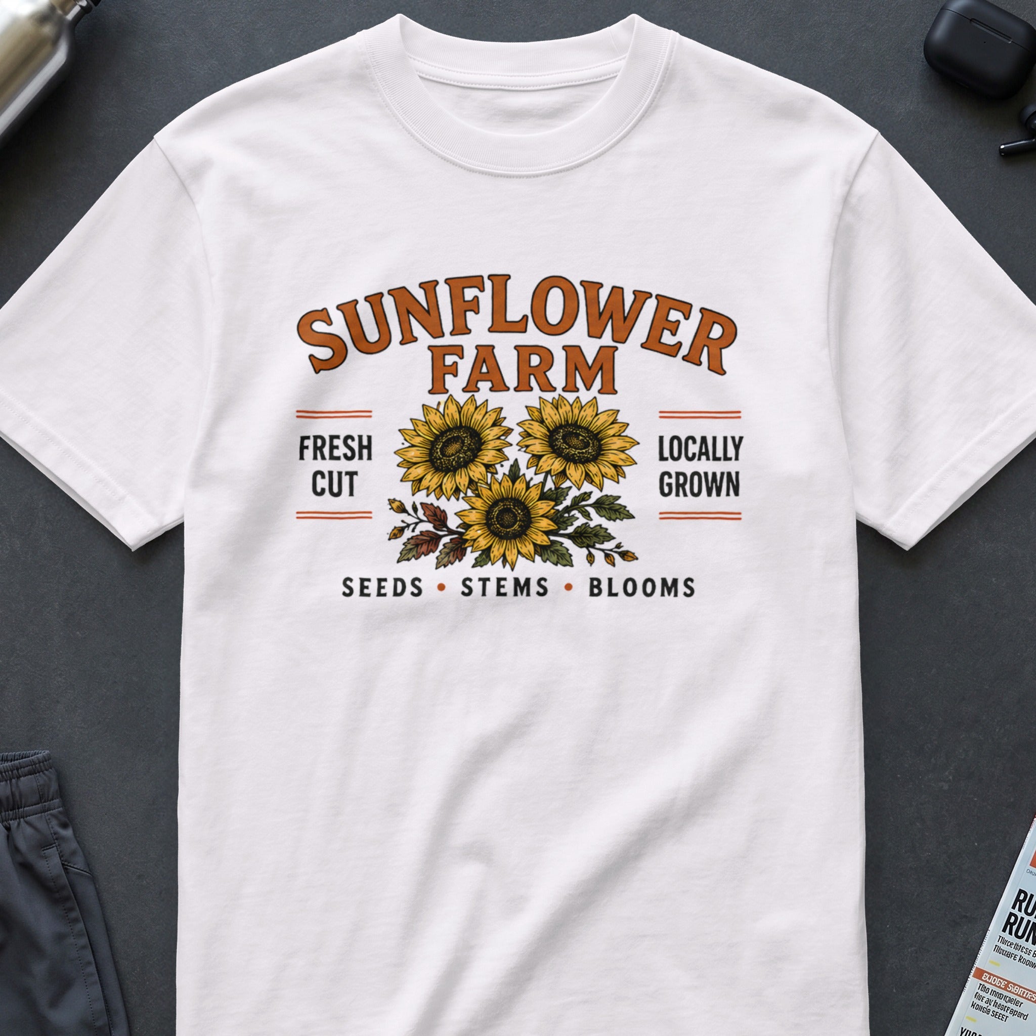 White t-shirt with "Sunflower Farm" text and three illustration sunflowers.