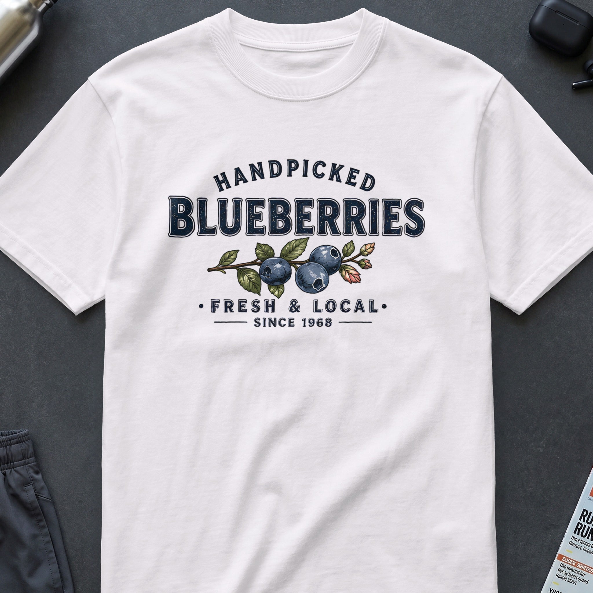 White t-shirt with "Handpicked Blueberries Fresh & Local Since 1968" graphic.