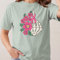 Skeleton hand with pink flowers and breast cancer ribbon.