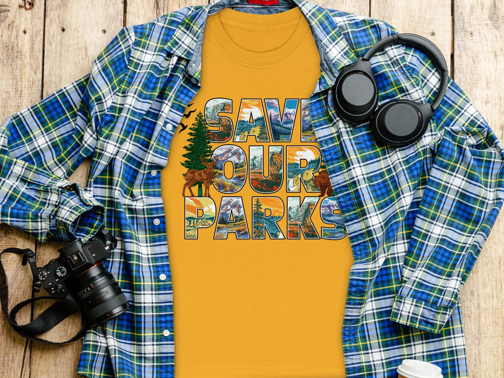 Yellow t-shirt with "Save Our Parks" text and nature scenes, plus a flannel shirt.