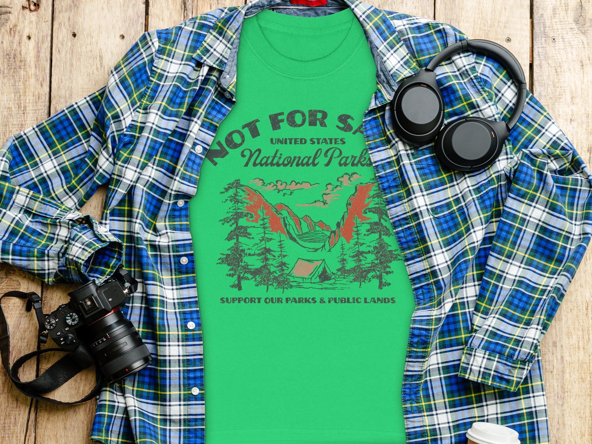 Green t-shirt with "Not for Sale United States National Parks" text and camping graphic.