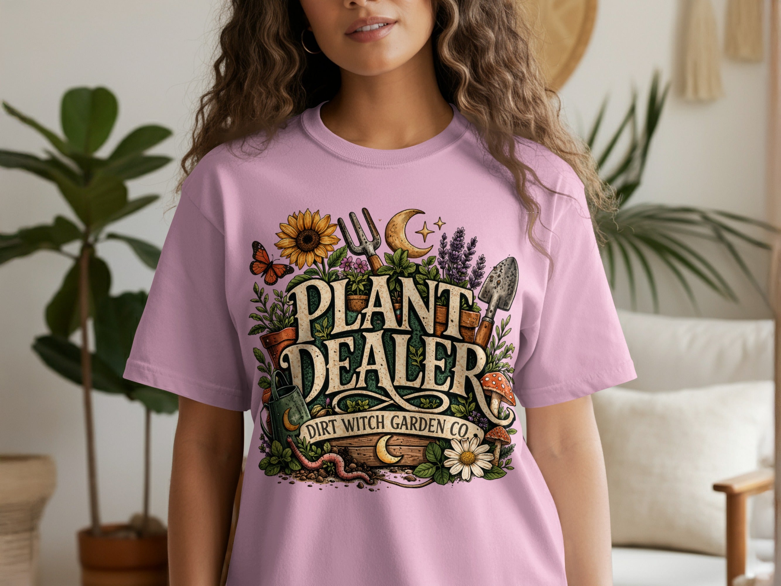Pink t-shirt with "PLANT DEALER DIRT WITCH GARDEN CO." garden-themed graphic.