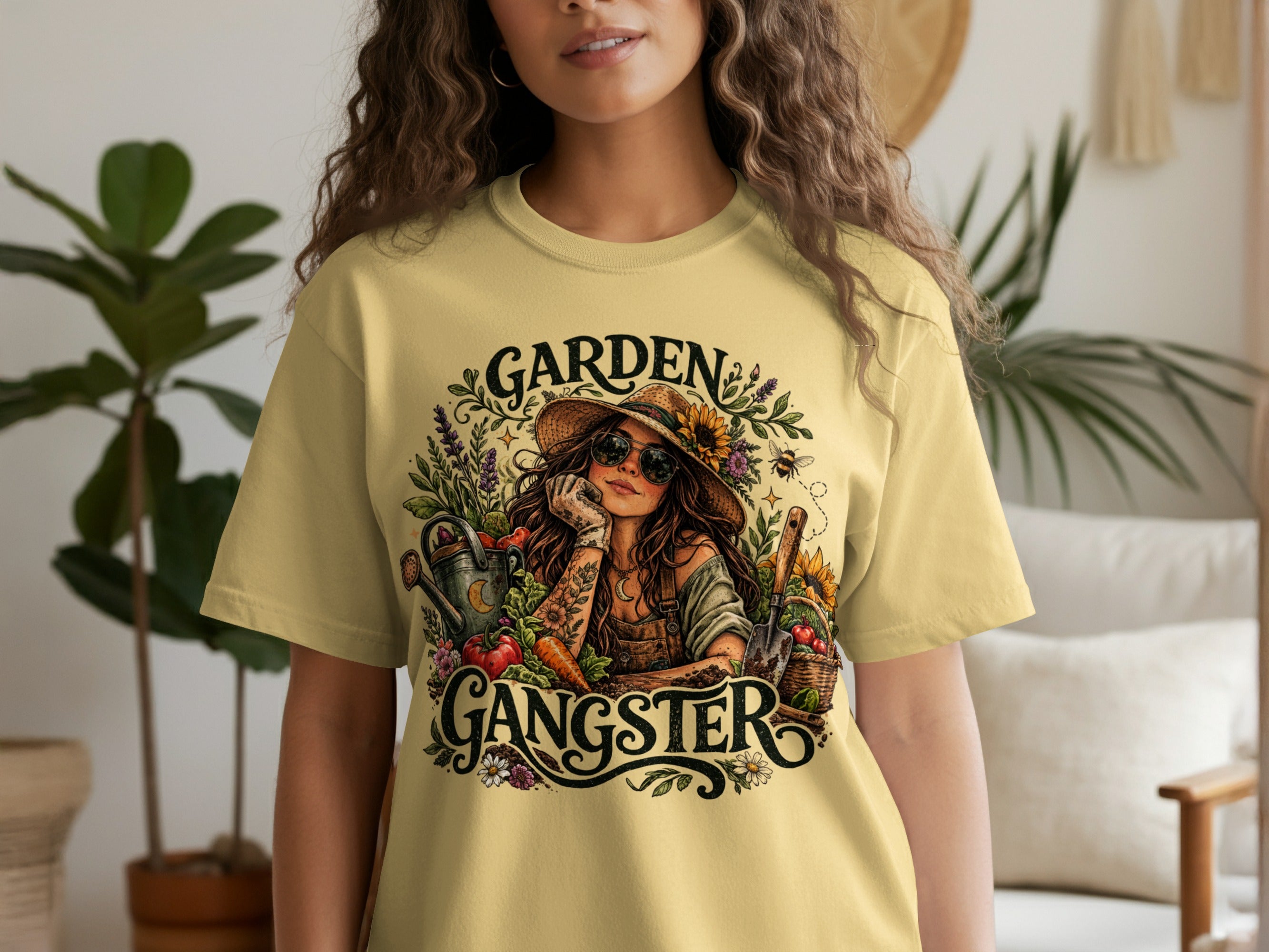 T-shirt graphic of "Garden Gangster" with a woman, gardening tools, and vegetables.