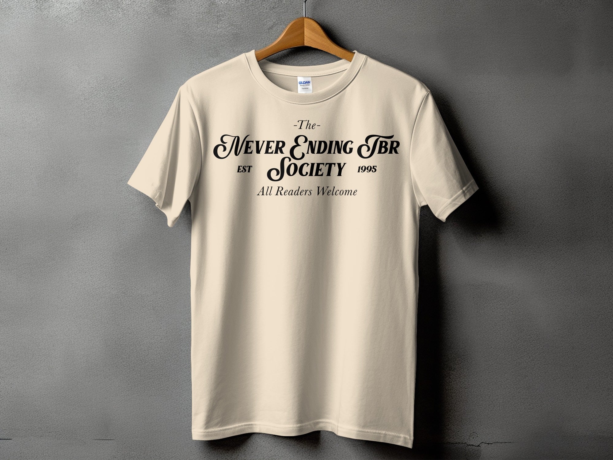 Cream t-shirt with black text: "The Never Ending TBR Society EST 1995 All Readers Welcome".