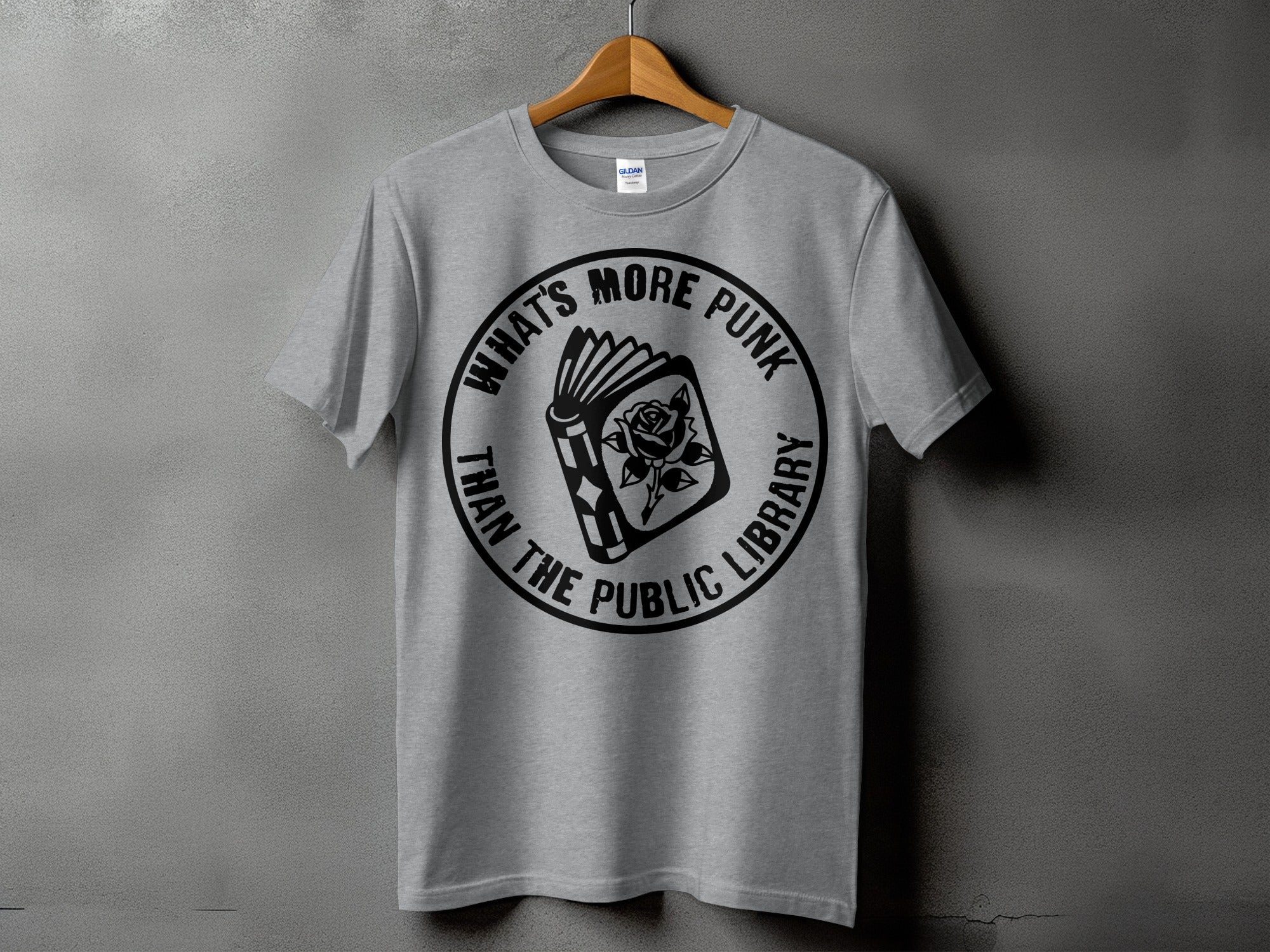 Grey t-shirt with circular graphic of open book and rose, text "WHAT'S MORE PUNK THAN THE PUBLIC LIBRARY".