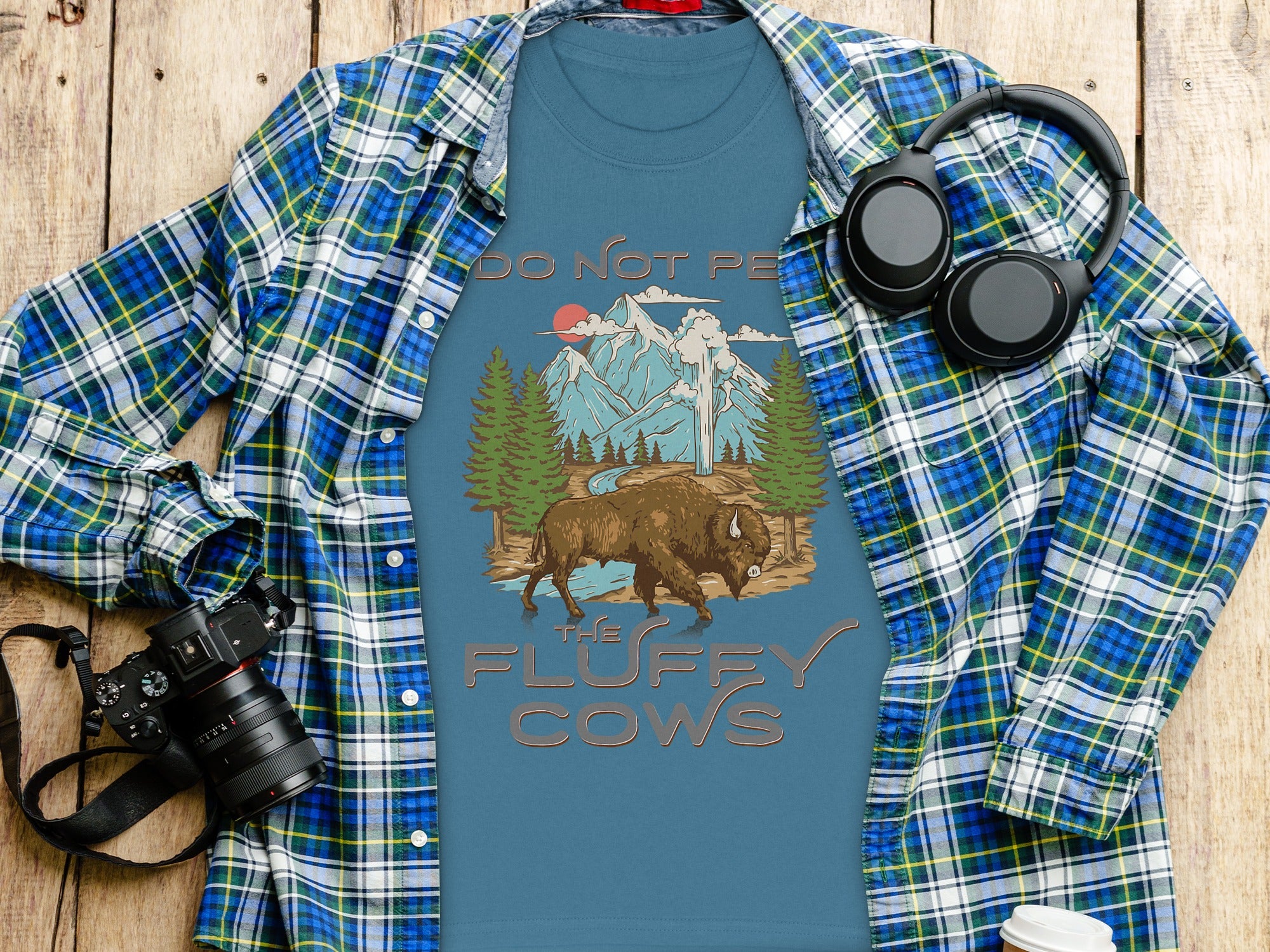 T-shirt with buffalo, mountains, and "Do Not Pet The Fluffy Cows" text.