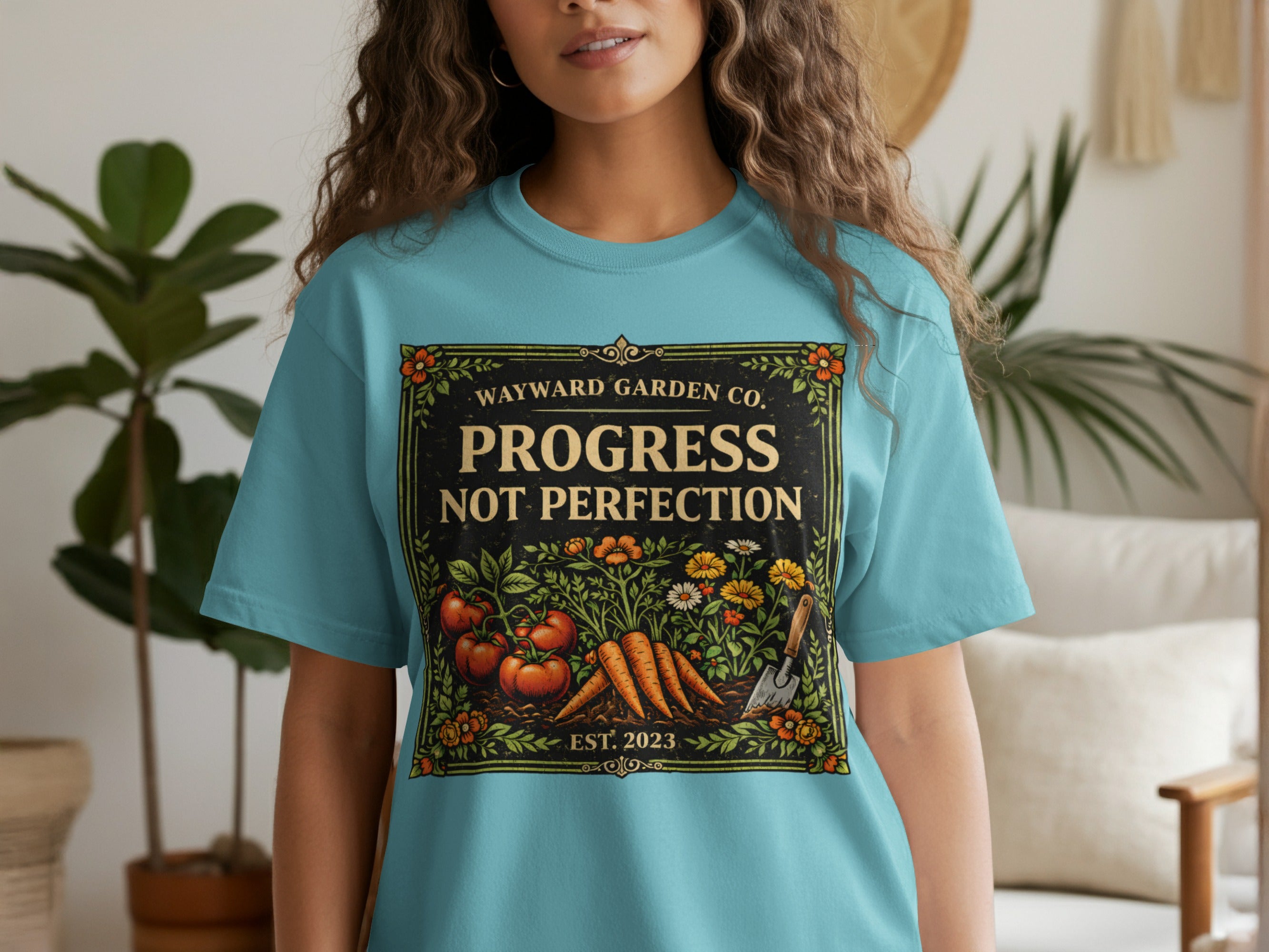 Aqua t-shirt with "Progress Not Perfection" garden graphic.