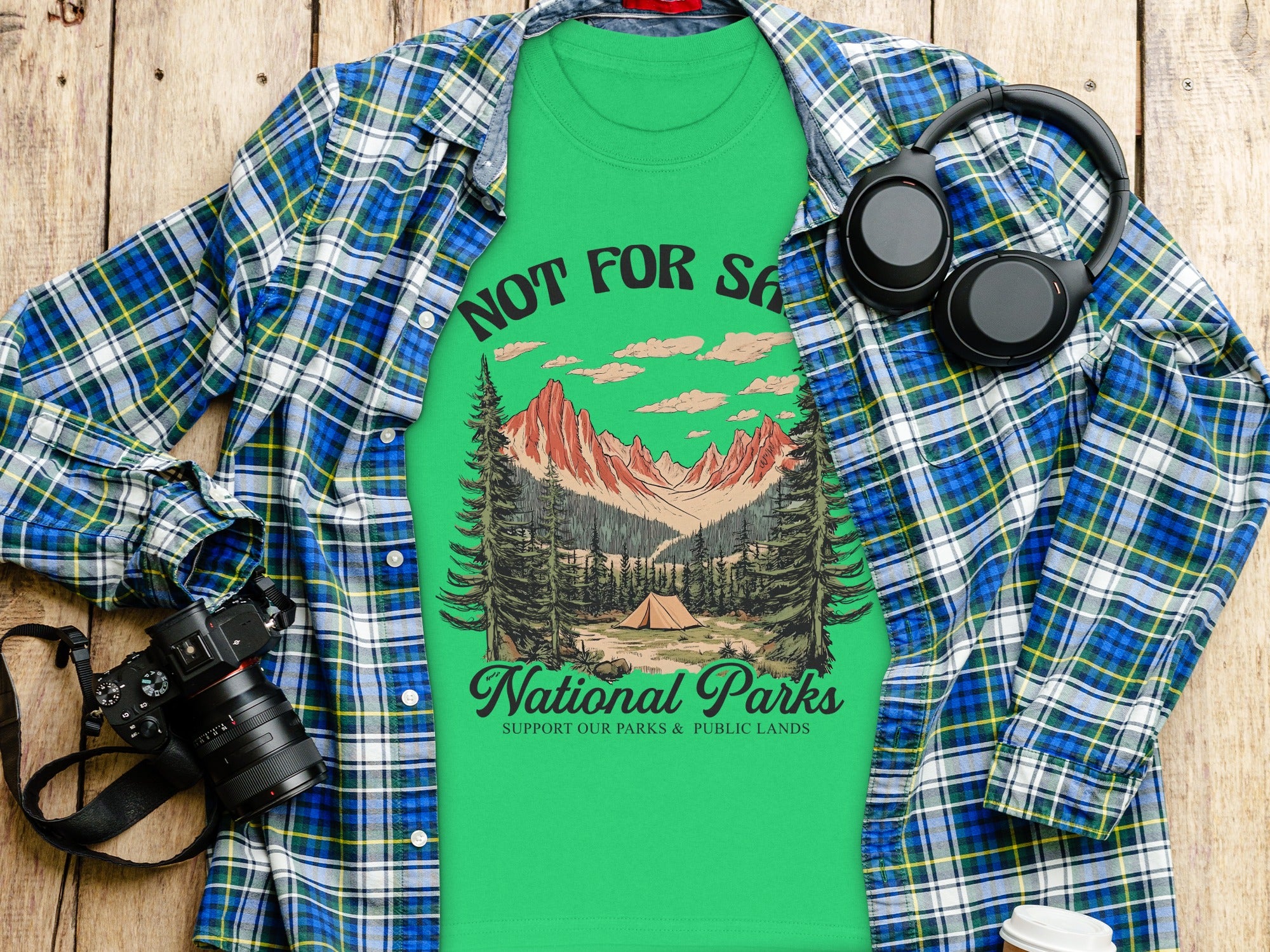 Green t-shirt with "Not For Sale" and mountains, tent, and "National Parks" text.