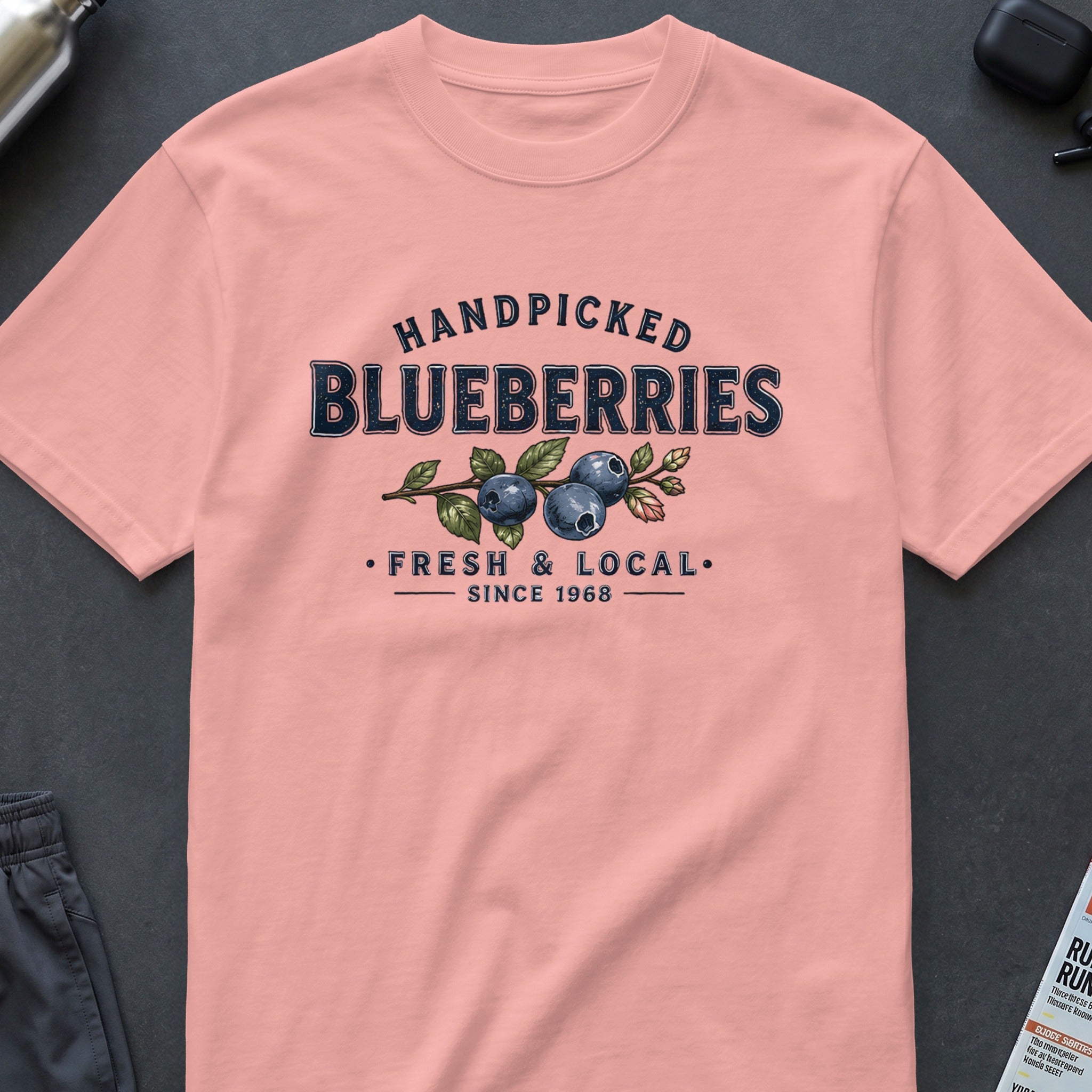 Pink t-shirt with "Handpicked Blueberries Fresh & Local Since 1968" graphic.