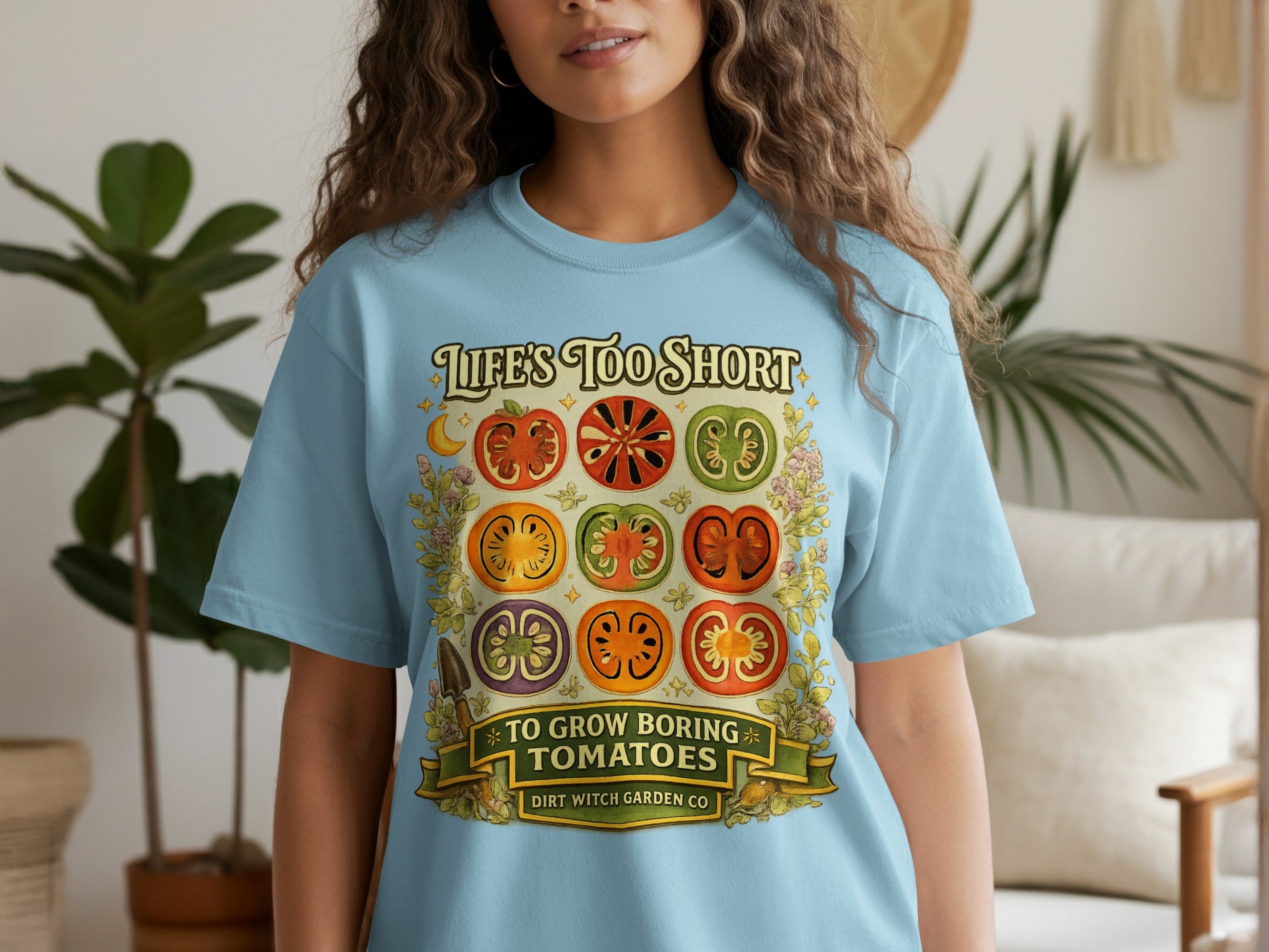 Light blue t-shirt with a graphic of sliced tomatoes and the text "Life's Too Short To Grow Boring Tomatoes."