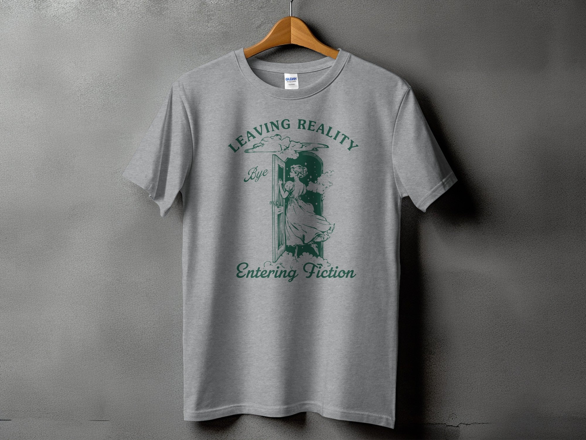 Grey t-shirt with "Leaving Reality, Bye, Entering Fiction" text and illustration.