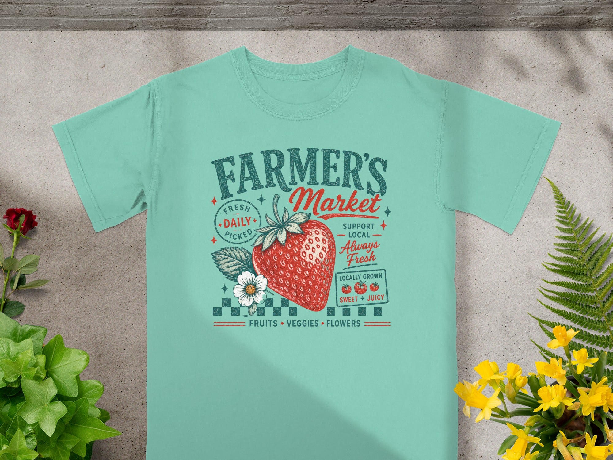 Teal t-shirt with "Farmer's Market" text, strawberry, and fresh produce graphics.