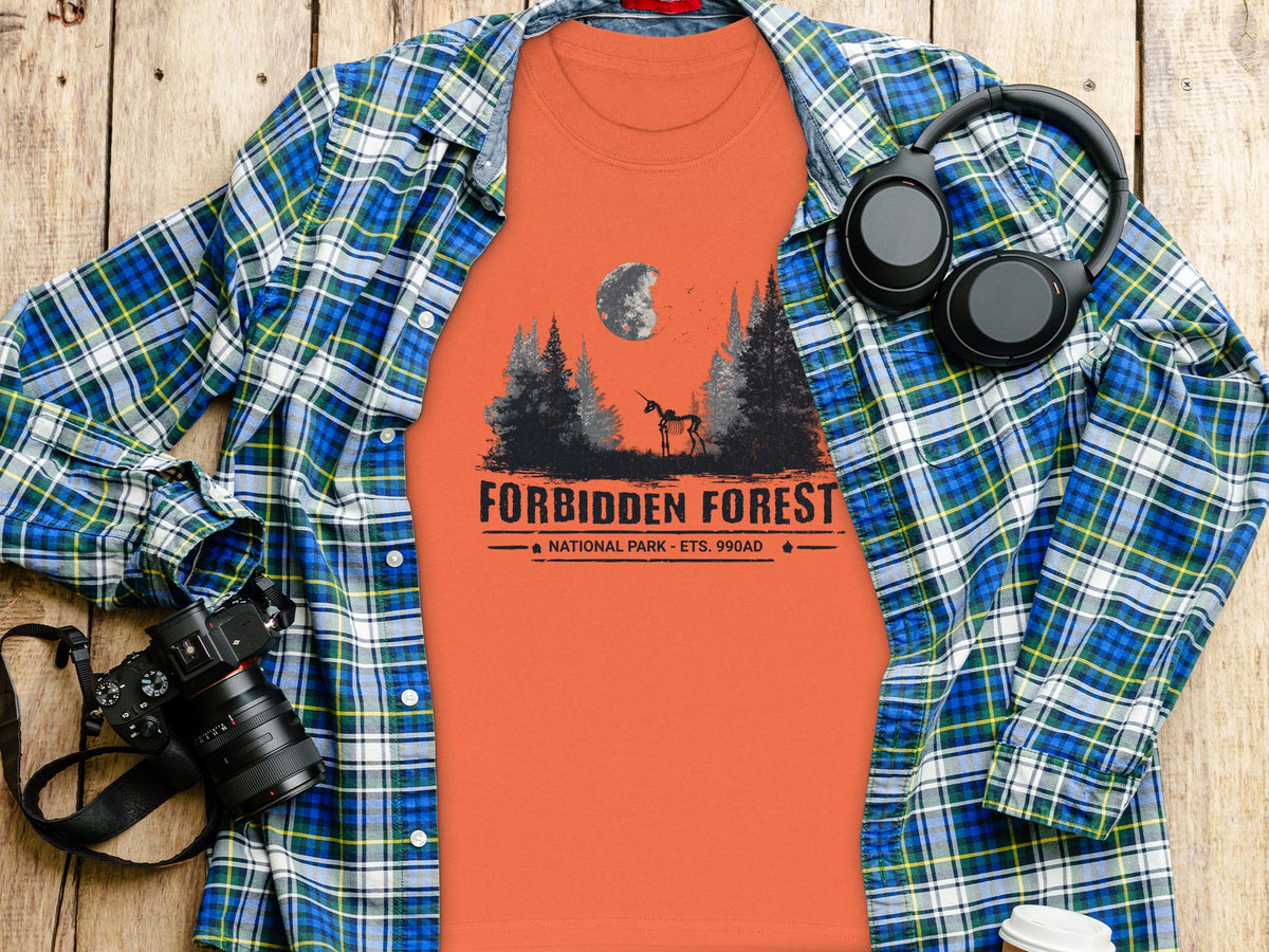 Orange t-shirt with "Forbidden Forest National Park" graphic and unicorn skeleton.