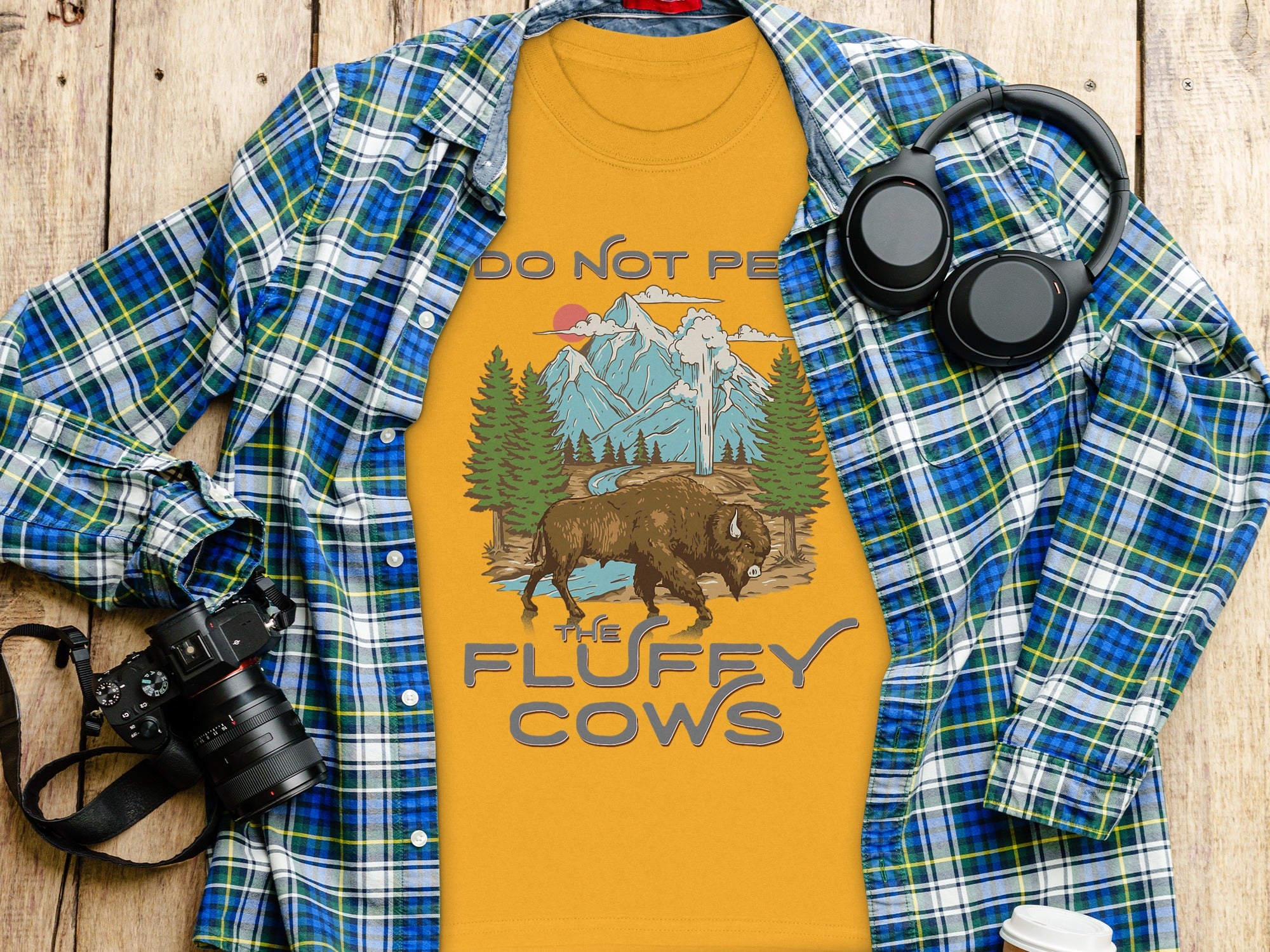 Yellow t-shirt with buffalo, mountains, and text "DO NOT PET THE FLUFFY COWS".