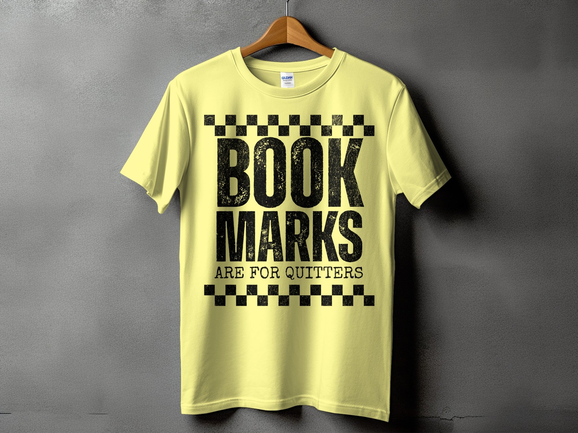 Yellow t-shirt with black text: BOOK MARKS ARE FOR QUITTERS.