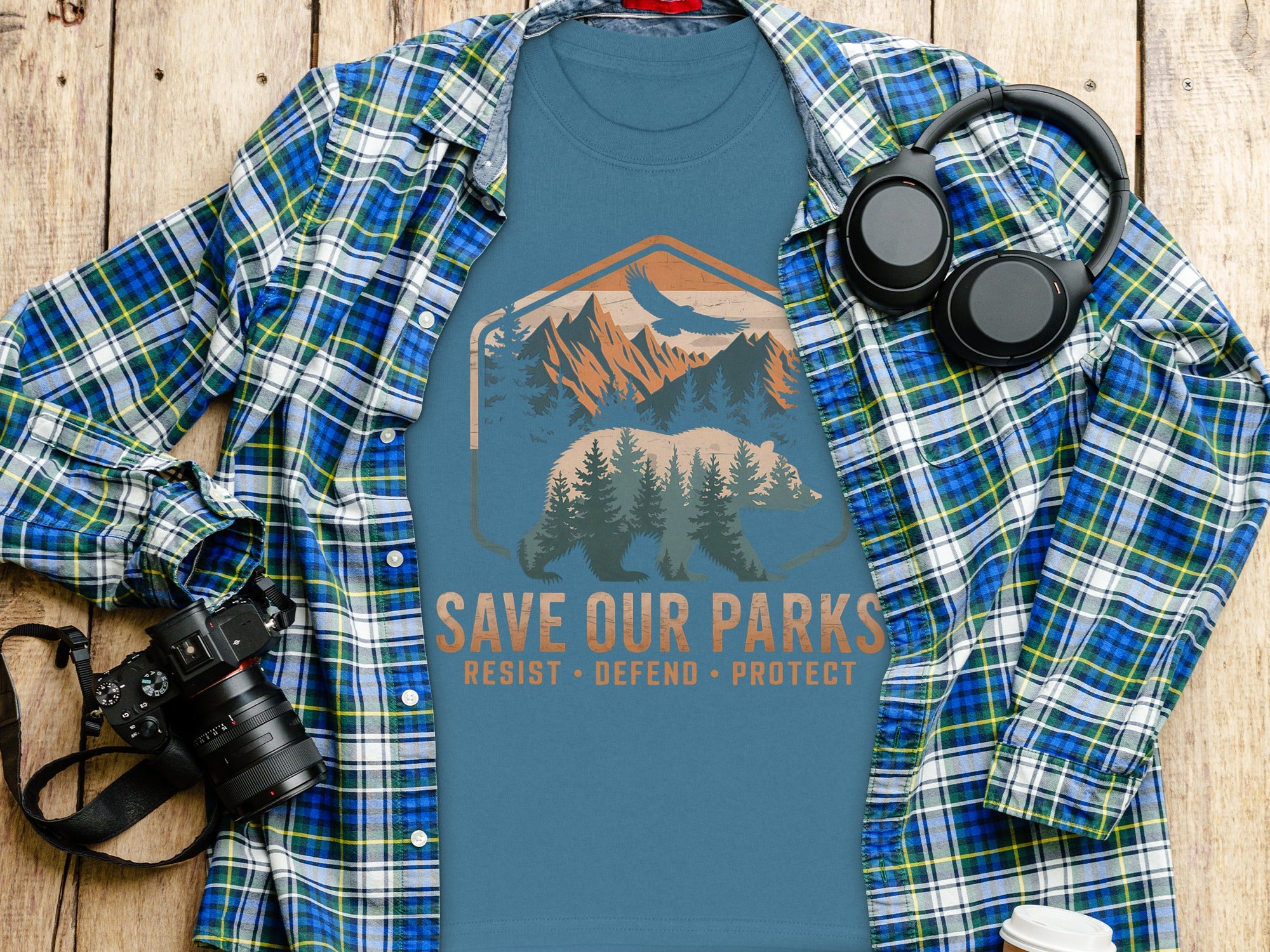Blue t-shirt with bear and mountains graphic reading "SAVE OUR PARKS."