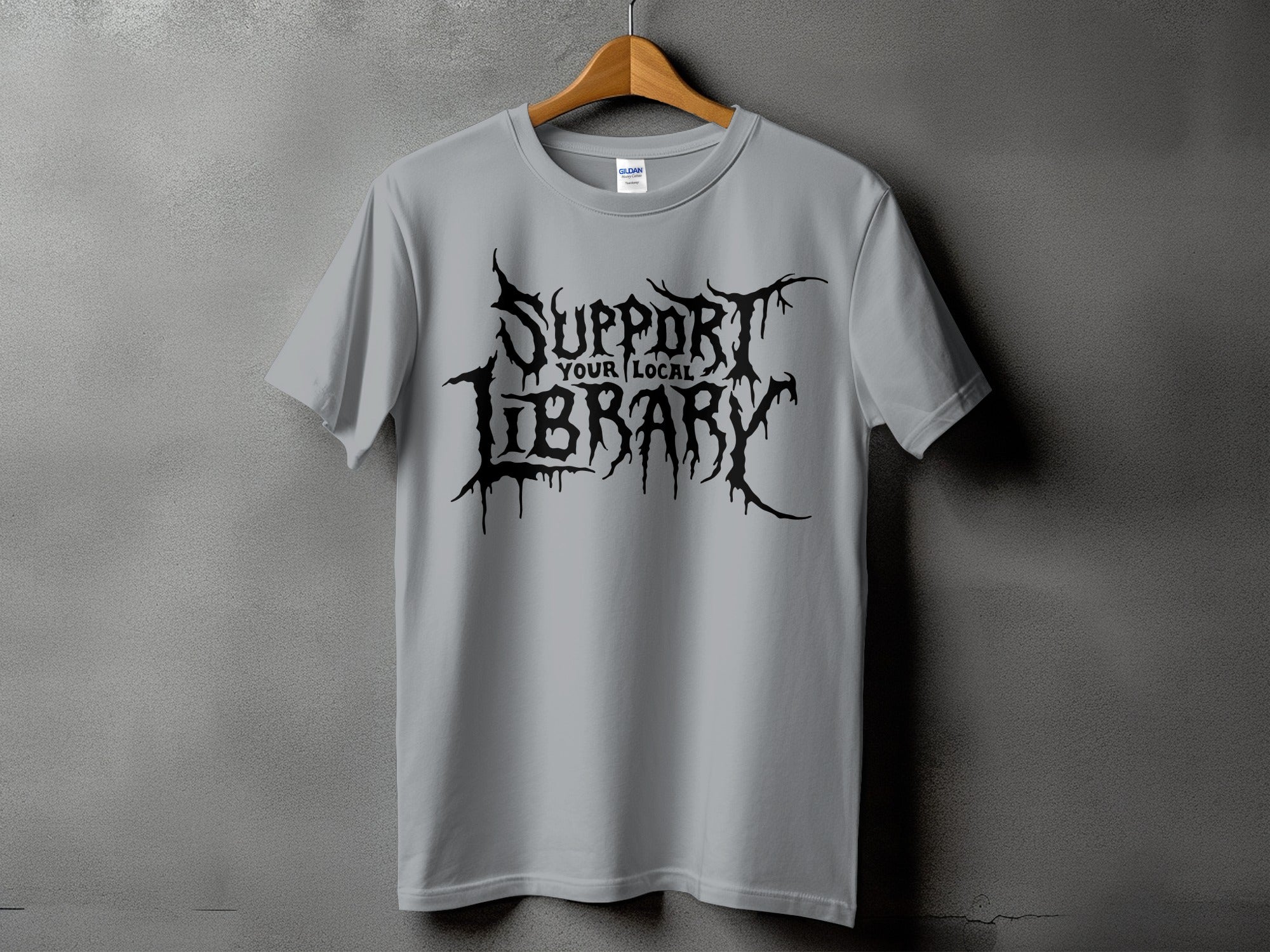 A grey t-shirt with black gothic text reading "SUPPORT YOUR LOCAL LIBRARY."