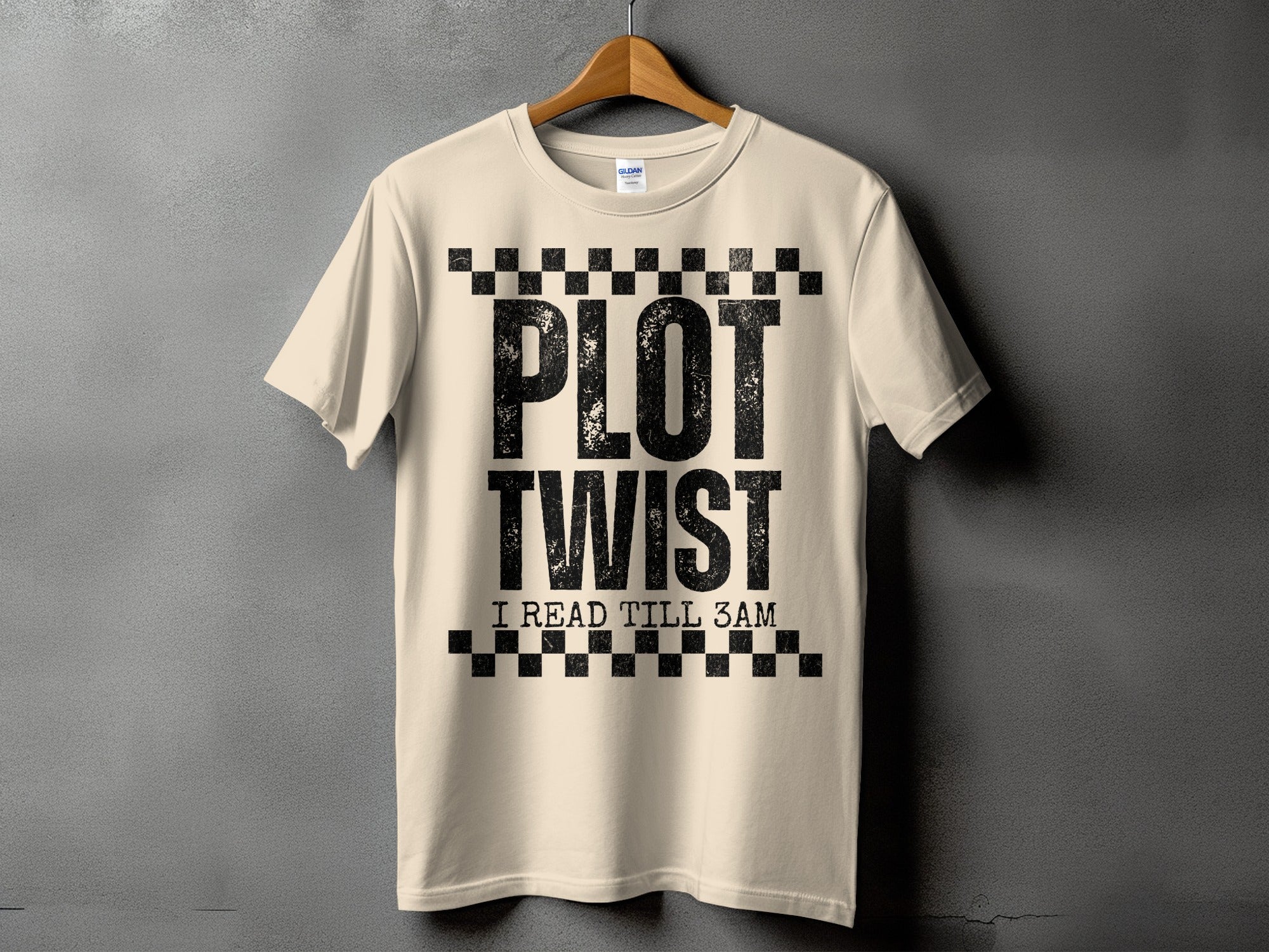 Cream t-shirt with black "PLOT TWIST I READ TILL 3AM" text and checkered boxes.
