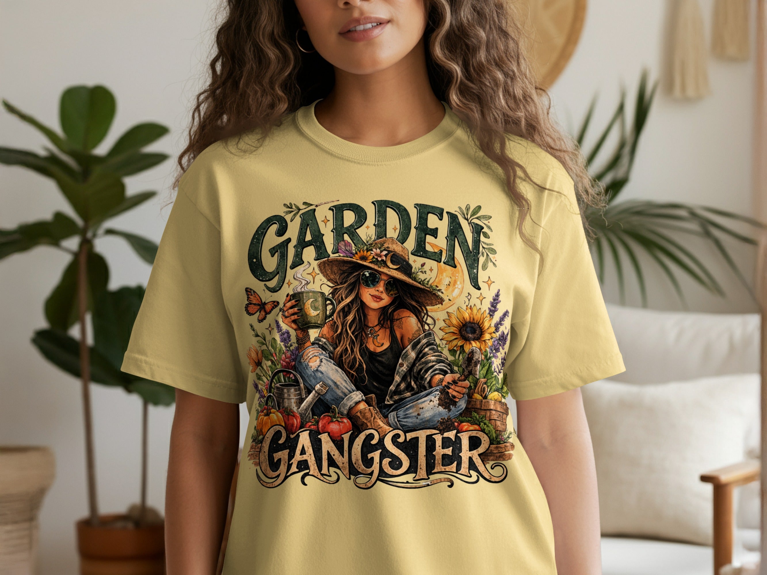 Yellow t-shirt with "GARDEN GANGSTER" graphic featuring a woman in a hat and jeans surrounded by plants.